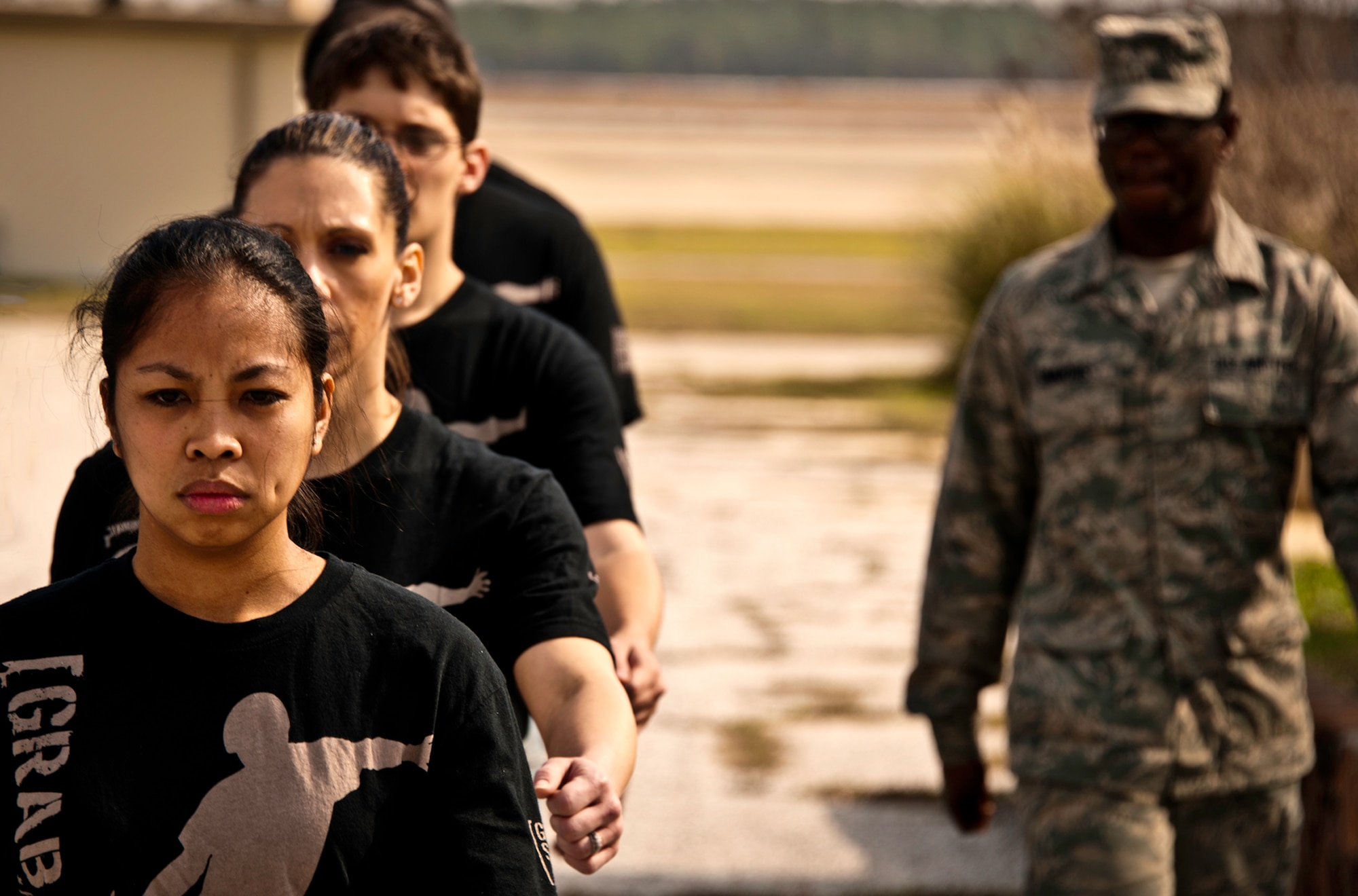 Trainee Alaine Savanich leads new 919th Special Operations Wing recruits in a formation during drill practice at Duke Field, Fla., Feb. 5.  This six-month-old introductory training is a new Air Force Reserve Command program to help recruits prepare for military life prior to going to basic military training. (U.S. Air Force photo/Tech. Sgt. Samuel King Jr.)