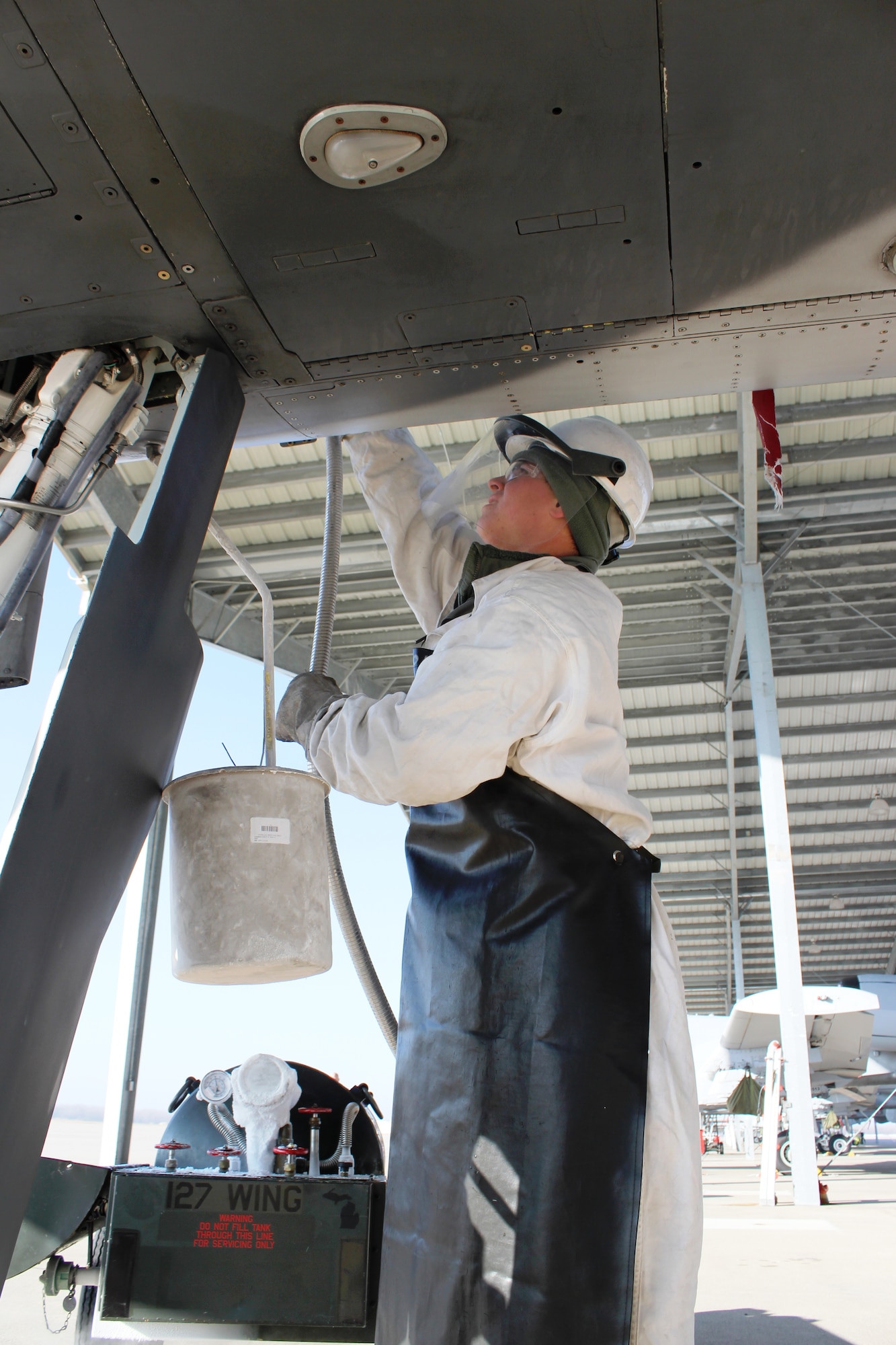 Airman 1st Class Zak Skelton adjusts a liquid oxygen transfer hose during a LOX servicing procedure on an A-10 Thunderbolt II aircraft Feb. 5, 2012, at Selfridge Air National Guard Base, Mich. Skelton is a crew chief with the 127th Aircraft Maintenance Squadron, a component of the Michigan Air National Guard. (U.S. Air Force photo by TSgt. Dan Heaton)