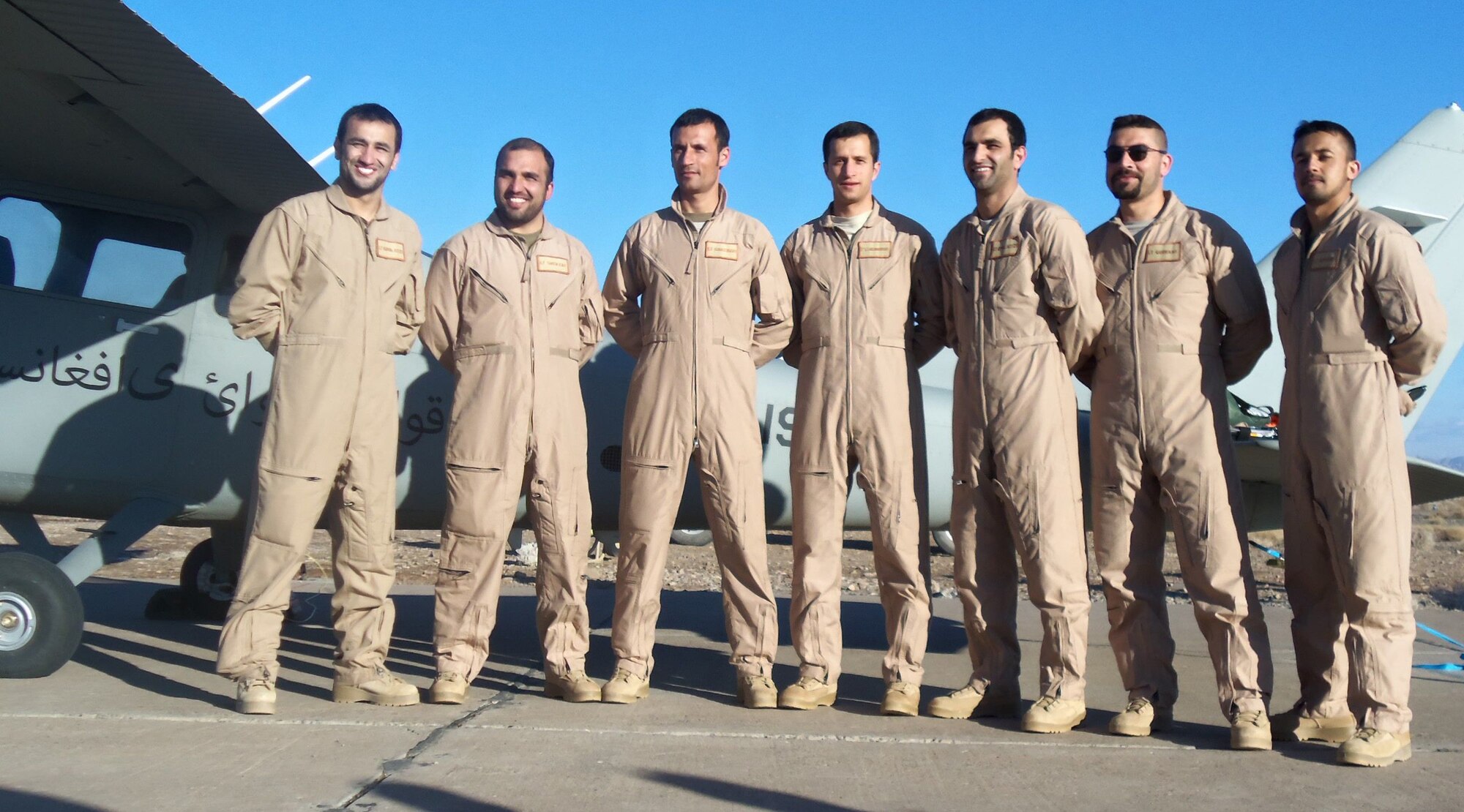 Seven Afghan pilots pose for a picture following graduation from a flight screening course Feb. 2, at Shindand Air Base, Afghanistan. The pilot candidates, from provinces throughout Afghanistan, are graduates from the National Military Academy of Afghanistan as well as Initial Officer Training, held in the United Kingdom and since graduation have been enrolled in the Kabul English Language Training Center where they've studied and developed the English language needed to fly.(courtesy photo)