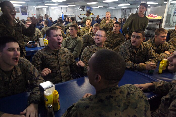 Marines with the 24th Marine Expeditionary Unit, cheer while watching the Super Bowl in the ship’s chow hall, Feb. 5. Marines and Sailors aboard the USS Gunston Hall crammed into office spaces, lounge areas, gyms, the chow hall and anywhere else with a television to watch the Super Bowl while at sea. The 24th MEU is conducting their Certification Exercise (CERTEX) with Iwo Jima Amphibious Ready Group, scheduled Jan. 27 to Feb. 17, which includes a series of missions intended to evaluate and certify the unit for their upcoming deployment.
