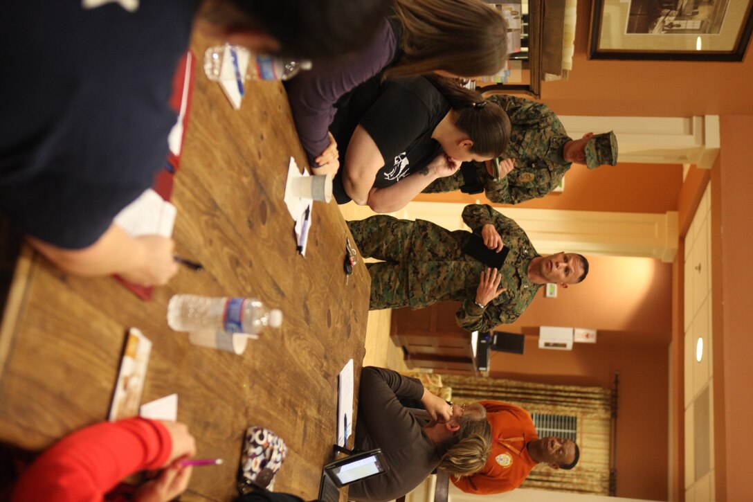 Col. Daniel J. Lecce, Marine Corps Base Camp Lejeune commanding officer, and members of the Provost Marshal's Office speak with base housing residents during a Community Watch meeting held at the Atlantic Marine Corps Community Bicentennial Community Center, Jan. 6.