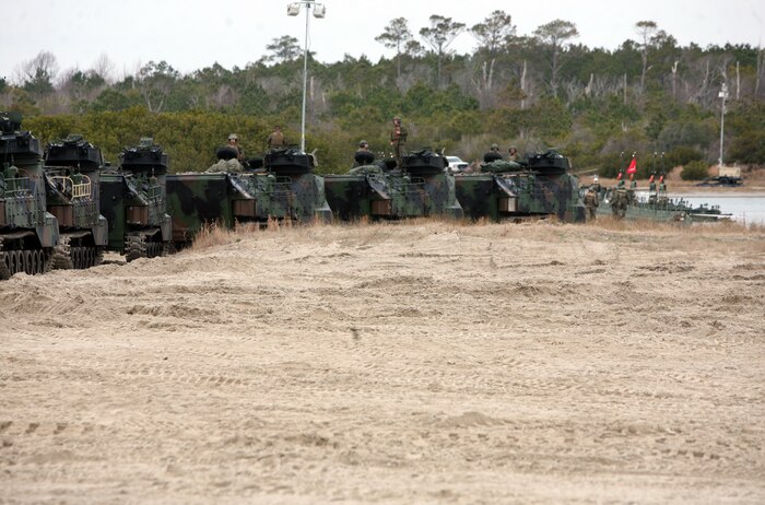 Eighteen armored assault vehicles wait to cross an improved ribbon bridge Feb. 6, 2012, aboard Camp Lejeune, N.C. Marines with Bridge Company, 8th Engineer Support Battalion, 2nd Marine Logistics Group set up the IRB to transport vehicles from one side of the waterway to the other. This event was part of exercise Bold Alligator 2012, an exercise that tested the Marine Corps’ amphibious readiness.  (Photo by Sgt. Rachael K. A. Moore)