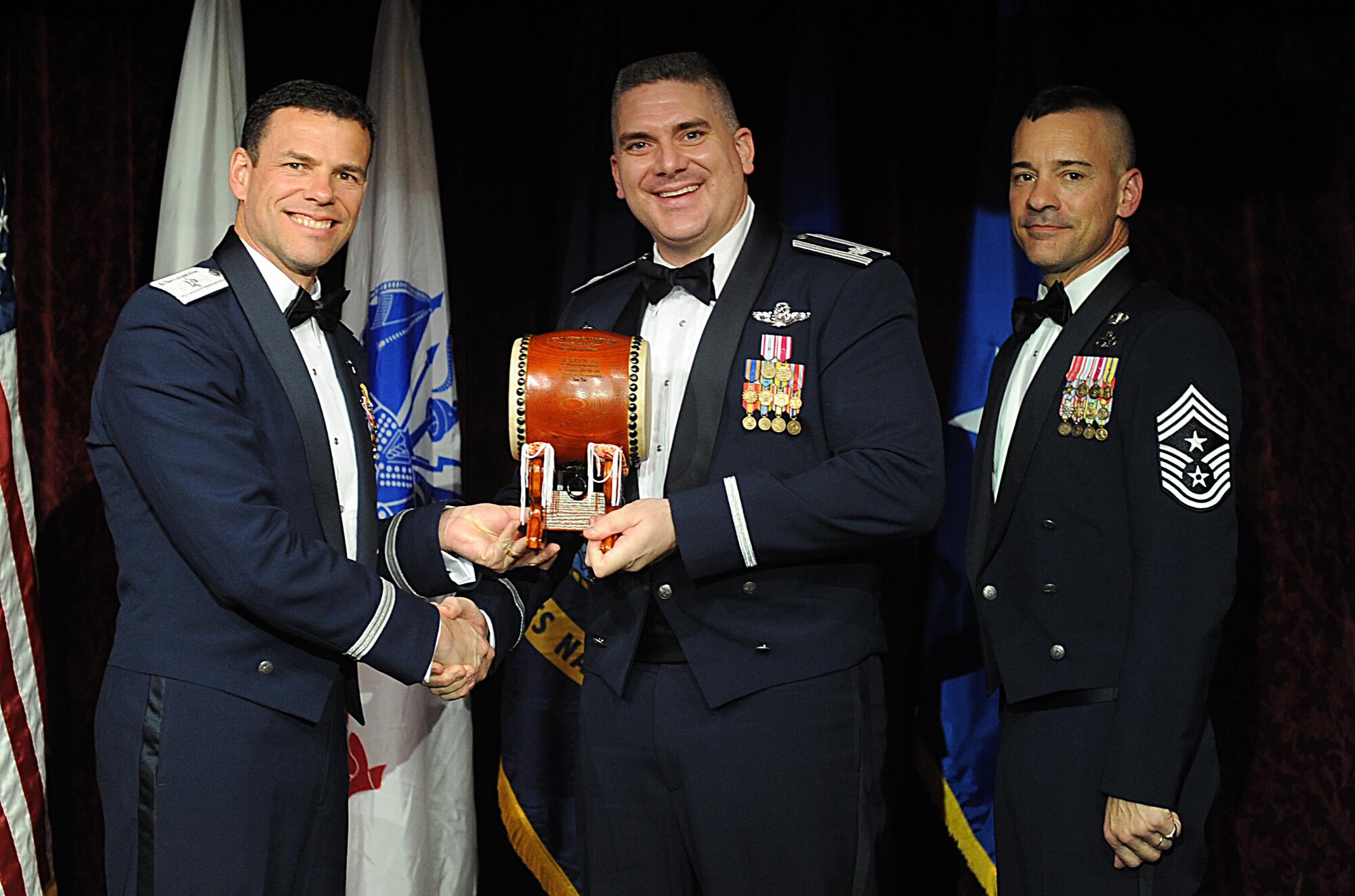 U.S. Air Force Lt. Col.Dave St Onge, on behalf of Capt. Joseph Andresky, accepts the Team Kadena Company Grade Officer of the Year Award from U.S. Air Force Brig. Gen. Matthew Molloy, 18th Wing commander, during Kadena's annual awards ceremony at the Rocker NCO Club on Kadena Air Base, Japan, Feb. 4, 2012. The awards were for Team Kadena and Wing level. (U.S Air Force photo by Airman 1st Class Brooke P. Beers/Released)