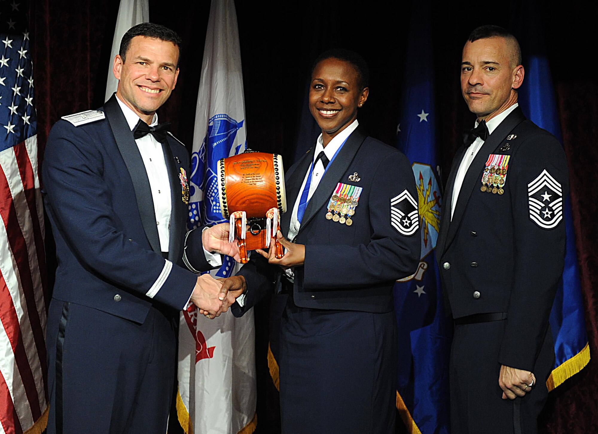 U.S. Air Force Senior Master Sgt. Kimberly Turner, accepts the Team Kadena Senior NCO of the Year Award from U.S. Air Force Brig. Gen. Matthew Molloy, 18th Wing commander, during Kadena's annual awards ceremony at the Rocker NCO Club on Kadena Air Base, Japan, Feb. 4, 2012. The awards were for Team Kadena and Wing level. (U.S Air Force photo by Airman 1st Class Brooke P. Beers/Released)