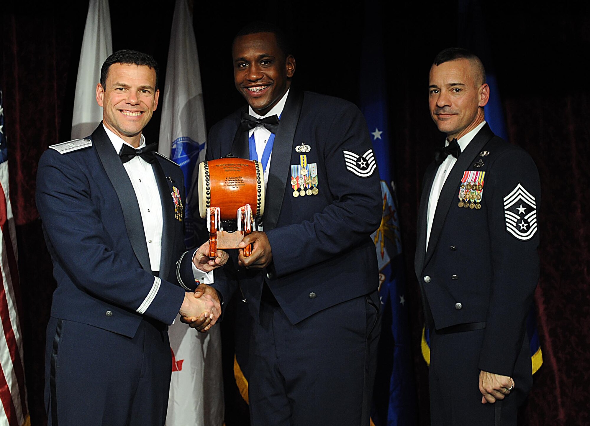 U.S. Air Force Tech. Sgt. Benjamin Puryear, accepts the Team Kadena NCO of the Year Award from U.S. Air Force Brig. Gen. Matthew Molloy, 18th Wing commander, during Kadena's annual awards ceremony at the Rocker NCO Club on Kadena Air Base, Japan, Feb. 4, 2012. The awards were for Team Kadena and Wing level. (U.S Air Force photo by Airman 1st Class Brooke P. Beers/Released)