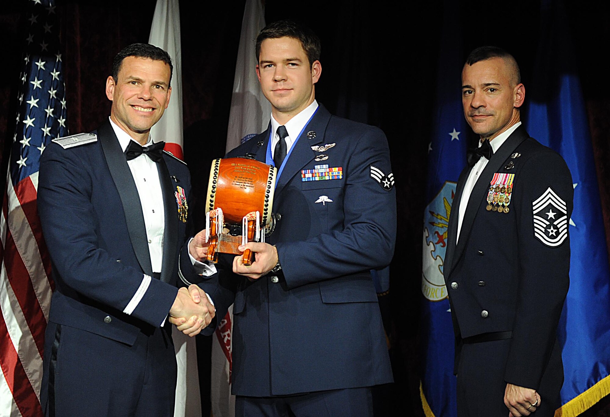 U.S. Air Force Senior Airman David Craig, accepts the Team Kadena Junior Enlisted of the Year Award from U.S. Air Force Brig. Gen. Matthew Molloy, 18th Wing commander, during Kadena's annual awards ceremony at the Rocker NCO Club on Kadena Air Base, Japan, Feb. 4, 2012. The awards were for Team Kadena and Wing level. (U.S Air Force photo by Airman 1st Class Brooke P. Beers/Released)