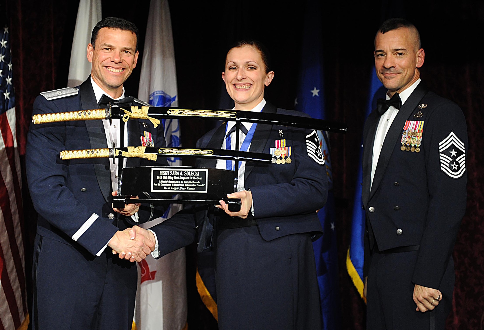 U.S. Air Force Master Sgt. Sara Soleski accepts the 18th Wing First Sergeant of the year award from U.S. Air Force Brig. Gen. Matthew Molloy, 18th Wing commander, during Kadena's annual awards ceremony at the Rocker NCO Club on Kadena Air Base, Japan, Feb.4, 2012. The awards were for Team Kadena and Wing level. (U.S Air Force photo by Airman 1st Class Brooke P. Beers/Released)