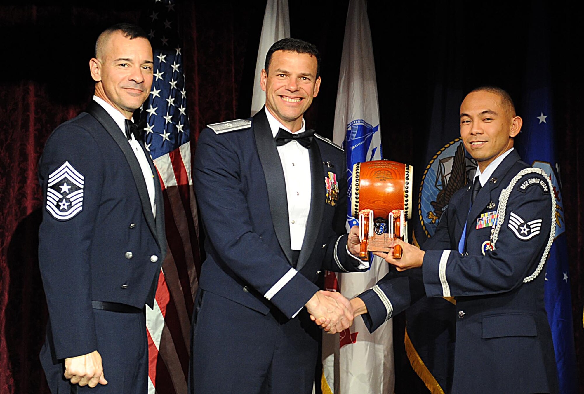 U.S. Air Force Staff Sgt. Marlon Quitos, accepts the Kadena honor guard Noncommissioned Officer of the year award from U.S. Air Force Brig. Gen. Matthew Molloy, 18th Wing commander, during Kadena's annual awards ceremony at the Rocker NCO Club on Kadena Air Base, Japan, Feb. 4, 2012. The awards were for Team Kadena and Wing level. (U.S Air Force photo by Airman 1st Class Brooke P. Beers/Released)