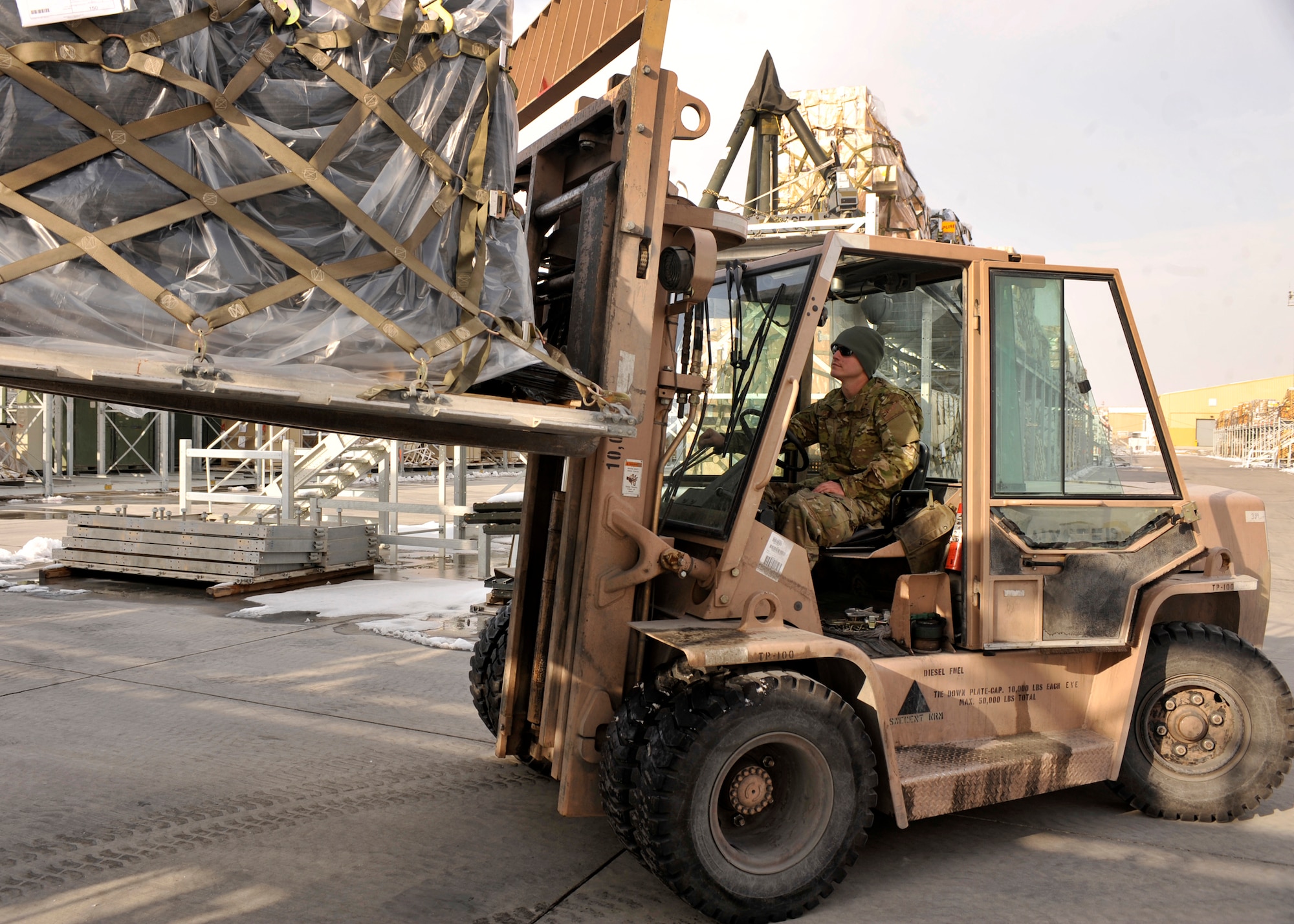 BAGRAM AIRFIELD, Afghanistan-- Staff Sgt. Joshua Fleming operates a forklift at Bagram Airfield, Afghanistan, Feb. 6, 2012. Fleming is a ramp service load team chief with the 455 Expeditionary Aerial Port Squadron and is deployed from the 117th Air Refueling Wing, Kansas Air National Guard. (U.S. Air Force photo/Airman 1st Class Ericka Engblom)