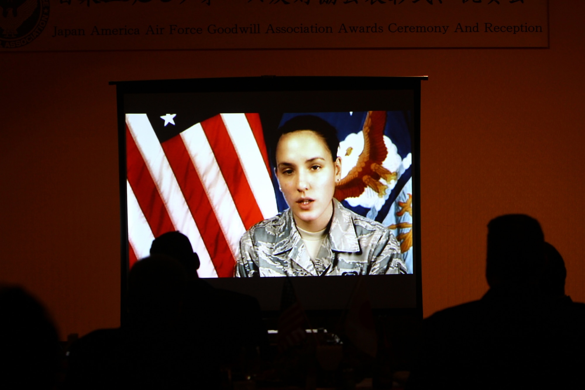 Senior Airman Veronica Cox delivers “thank you” remarks via a video at the Japan-America Air Force Goodwill Association awards ceremony at Naha Air Base, Feb. 3. Senior Airman Cox was unable to attend the ceremony due to a recent deployment. (Courtesy photo by Japan Air Self Defense Force Master Sgt. Tatsuya Hosobuchi)
