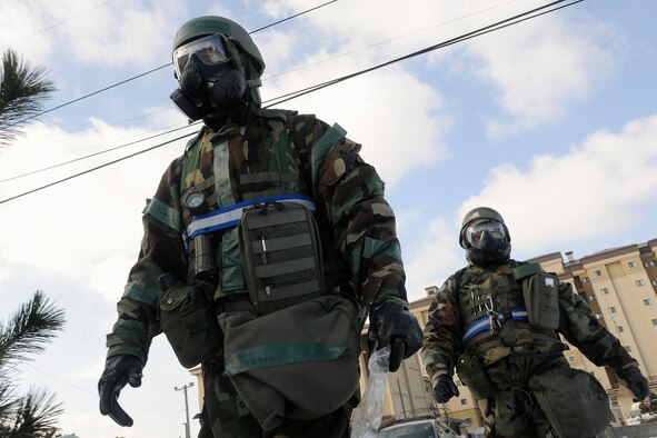 Staff Sgt. Demetrius Williams and Tech Sgt. Steven Jackson, 8th Comptroller Squadron finance members, walk around their facility to change chemical agent detection paper (M8) at stanchions around their facility at Kunsan Air Base, Republic of Korea, during a peninsula-wide operational readiness exercise Feb. 2, 2012. Kunsan participated in a PENORE to test its ability of performing during wartime conditions no matter what the season may be. (U.S. Air Force photo by Staff Sgt. Rasheen A. Douglas/Released)