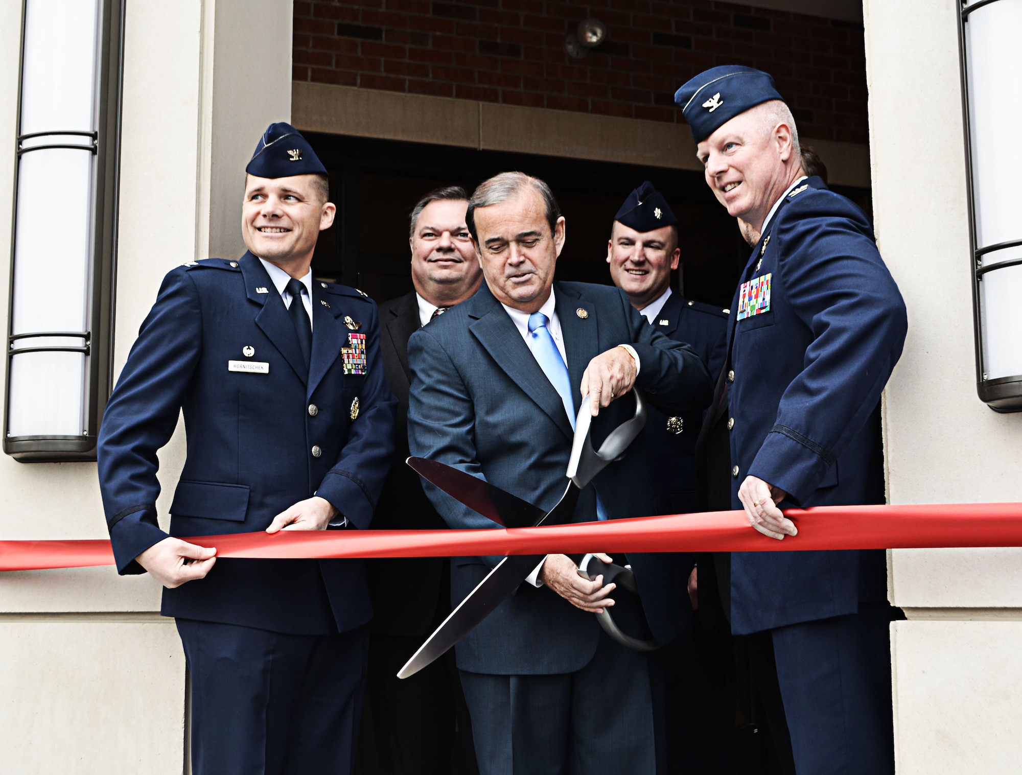 Illinois Congressman Jerry Costello prepares to cut the ribbon Feb. 6, 2012 to a new $7.4 million, 21,500 sq. ft. aeromedical evacuation facility at Scott Air Force Base, Ill., that he was instrumental in securing funding for.  He is flanked by Col. Michael Hornitschek, 375th Air Mobility Wing commander; Randy Pollard, representing Illinois Senator Mark Kirk’s office; Lt. Col. John Shuliger, 375th Civil Engineer Squadron commander; and Col. Ed Farley, 375th Aeromedical Evacuation Squadron commander.  The building will house 163 active-duty, Guard and Reserve personnel whose mission is to bring home the wounded, injured and ill patients around the globe. (U.S. Air Force photo/Karen Petitt)