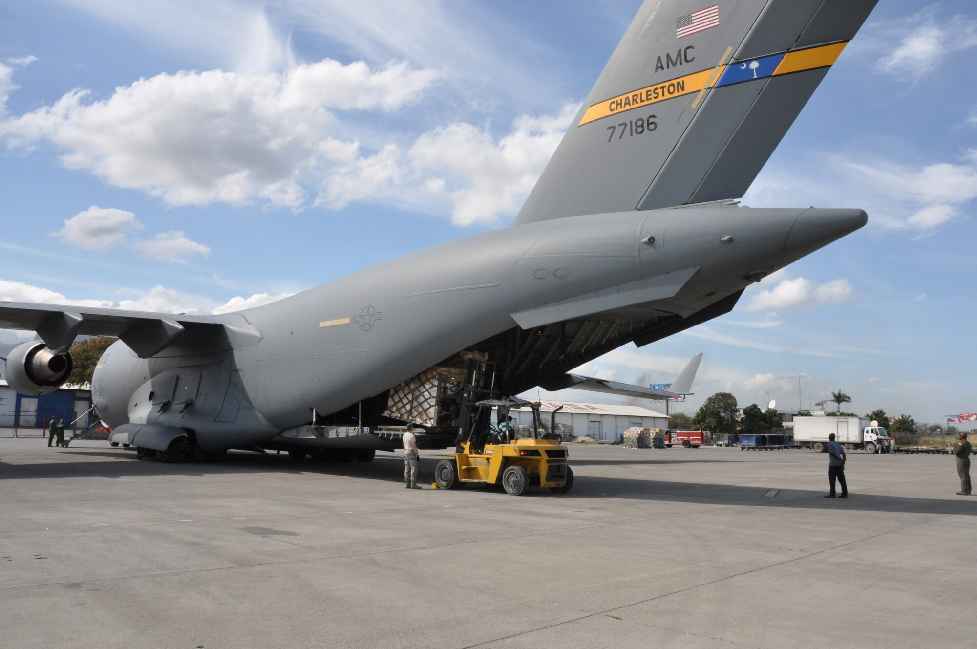 A C-17 Globemaster III from the 315th Airlift Wing and crew from the 701st Airlift Squadron delivers humanitarian aid in Port-Au-Price, Haiti.  The 315th Airlift delivered nearly 56,000 lbs. of cargo on a recent mission. (U.S. Air Force Photo/Capt. Wayne Capps)