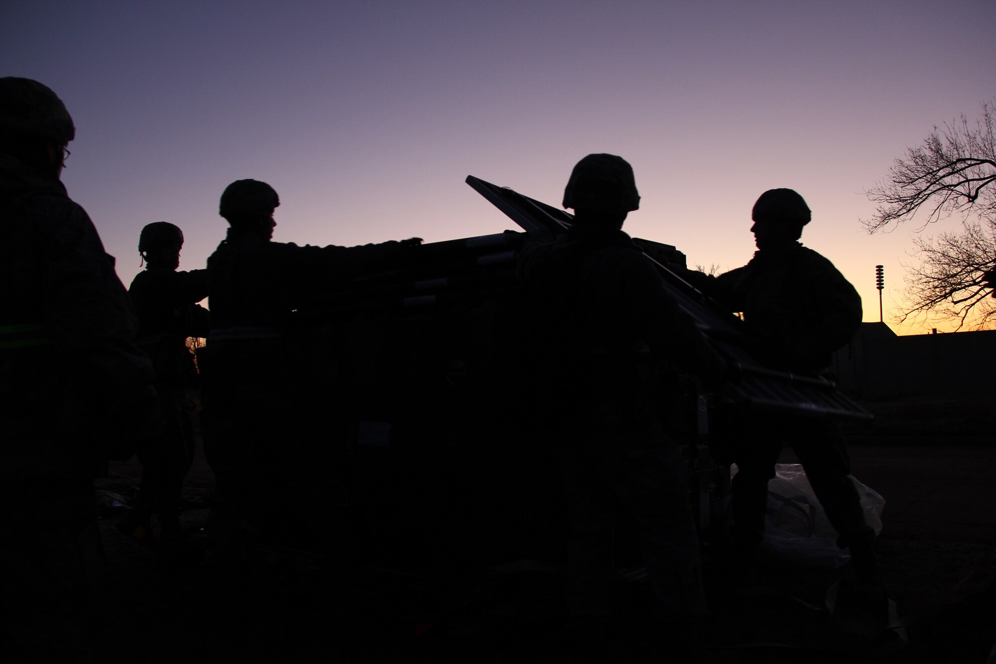 TINKER AIR FORCE BASE, Okla. – Airmen from the 31st Combat Communications Squadron unload cargo pallets as the sun rises during their unit’s compliance readiness inspection here Feb. 6. The 31st CBCS is one of three 3rd Combat Communications Group squadrons exercising its field capabilities at Glenwood Annex here Jan. 30 to Feb. 14. (U.S. Air Force photo by Robert Talenti)