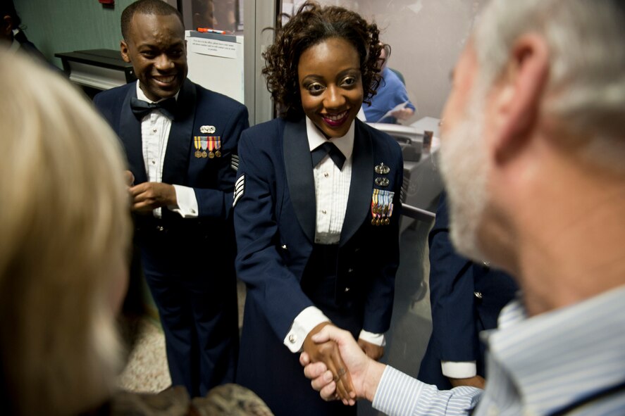 U.S. Air Force Staff Sgt. Rosalyn Moody, Tops in Blue vocalist, shakes hands with an audience member at the Mathis Auditorium, Valdosta, Ga., Feb. 2, 2012. Moody is an air transportation apprentice with the 436th Aerial Port Squadron out of Dover Air Force Base, Del. (U.S. Air Force photo by Staff Sgt. Jamal D. Sutter/Released)