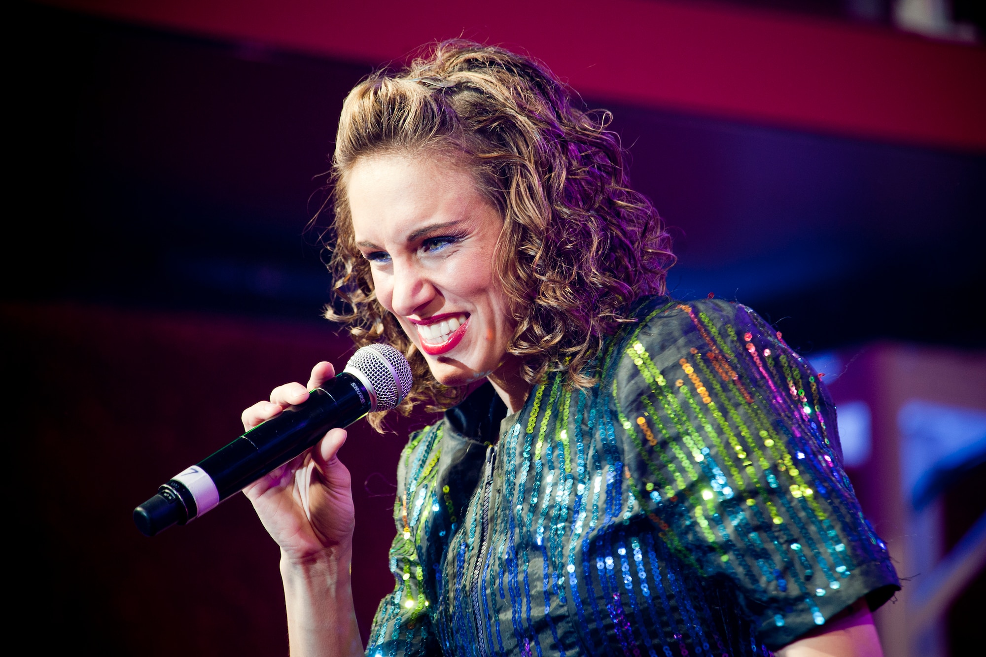 U.S. Air Force Senior Airman Kristen Wash, Tops in Blue vocalist, performs during a show at the Mathis Auditorium, Valdosta, Ga., Feb. 2, 2012. Tops in Blue tours worldwide in an effort to raise morale for Service members and their families. While entertaining, they also promote community relations, support recruiting efforts and serve as ambassadors for the U.S. and the Air Force. (U.S. Air Force photo by Staff Sgt. Jamal D. Sutter/Released)