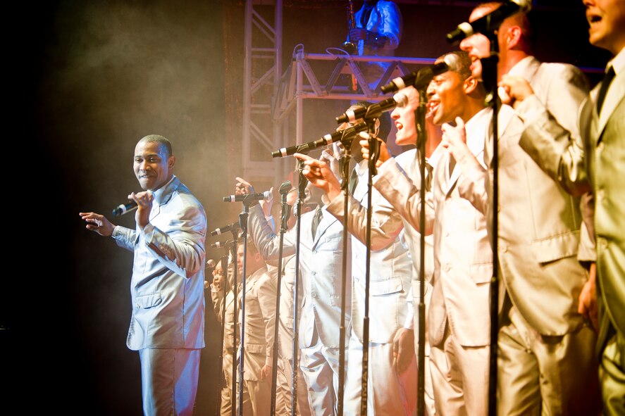 U.S. Air Force Senior Airman Jarrod Burton, Tops in Blue vocalist, leads a performance during a show at the Mathis Auditorium, Valdosta, Ga., Feb. 2, 2012. Burton is a water fuels maintenance journeyman with the 90th Civil Engineer Squadron out of Warren Air Force Base, Wyo. (U.S. Air Force photo by Staff Sgt. Jamal D. Sutter/Released) 