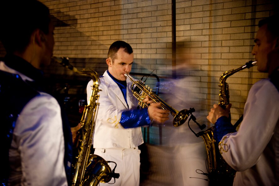 U.S. Air Force Senior Airman James Santos, Tops in Blue trumpet player, practices before show start with Airmen 1st Class Gabriel Villanueva and Ryan Ratkowski, Tops in Blue saxophone players, Feb. 2, 2012, in Valdosta, Ga. Tops in Blue is an active duty U.S. Air Force special unit made up of amateur performers who put on shows for military families all over the world. (U.S. Air Force photo by Staff Sgt. Jamal D. Sutter/Released)  