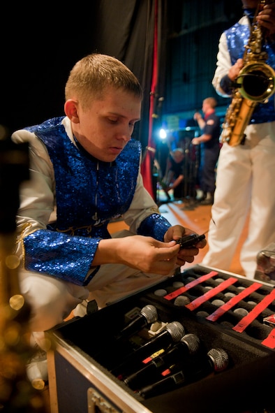 U.S. Air Force Airman 1st Class Maxwell Hulett, Tops in Blue drummer, prepares audio equipment before show start, Feb. 2, 2012, in Valdosta, Ga. Hulett is an F-15E Strike Eagle  and U-2 avionics system apprentice with the 4th Aircraft Maintenance Squadron out of Seymour-Johnson Air Force Base, N.C. (U.S. Air Force photo by Staff Sgt. Jamal D. Sutter/Released)