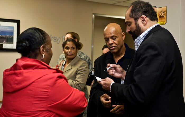 Franco Harris and Lyndell Mitchell, former National Football League players, sign autographs Feb. 3, 2012, at Nellis Air Force Base, Nev. Harris and Mitchell are volunteers for Soldiers' Angels, a volunteer-led, non profit organization that provides aid and comfort to the men and women of the U.S. Army, Marines, Navy, Air Force and Coast Guard, U.S. veterans and their families. (U.S. Air Force photo by Airman 1st Class Matthew Lancaster)