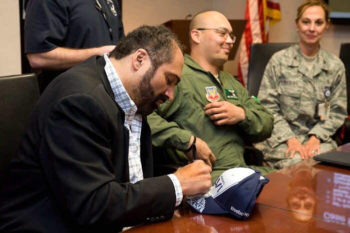Franco Harris, former National Football League player, autographs a Super Bowl hat for wounded warriors Feb. 3, 2012, at Nellis Air Force Base, Nev.  Harris is a volunteer for Soldiers' Angels, a volunteer-led, non profit organization that provides aid and comfort to the men and women of the U.S. Army, Marines, Navy, Air Force and Coast Guard, U.S. veterans and their families.  (U.S. Air Force photo by Airman 1st Class Matthew Lancaster)