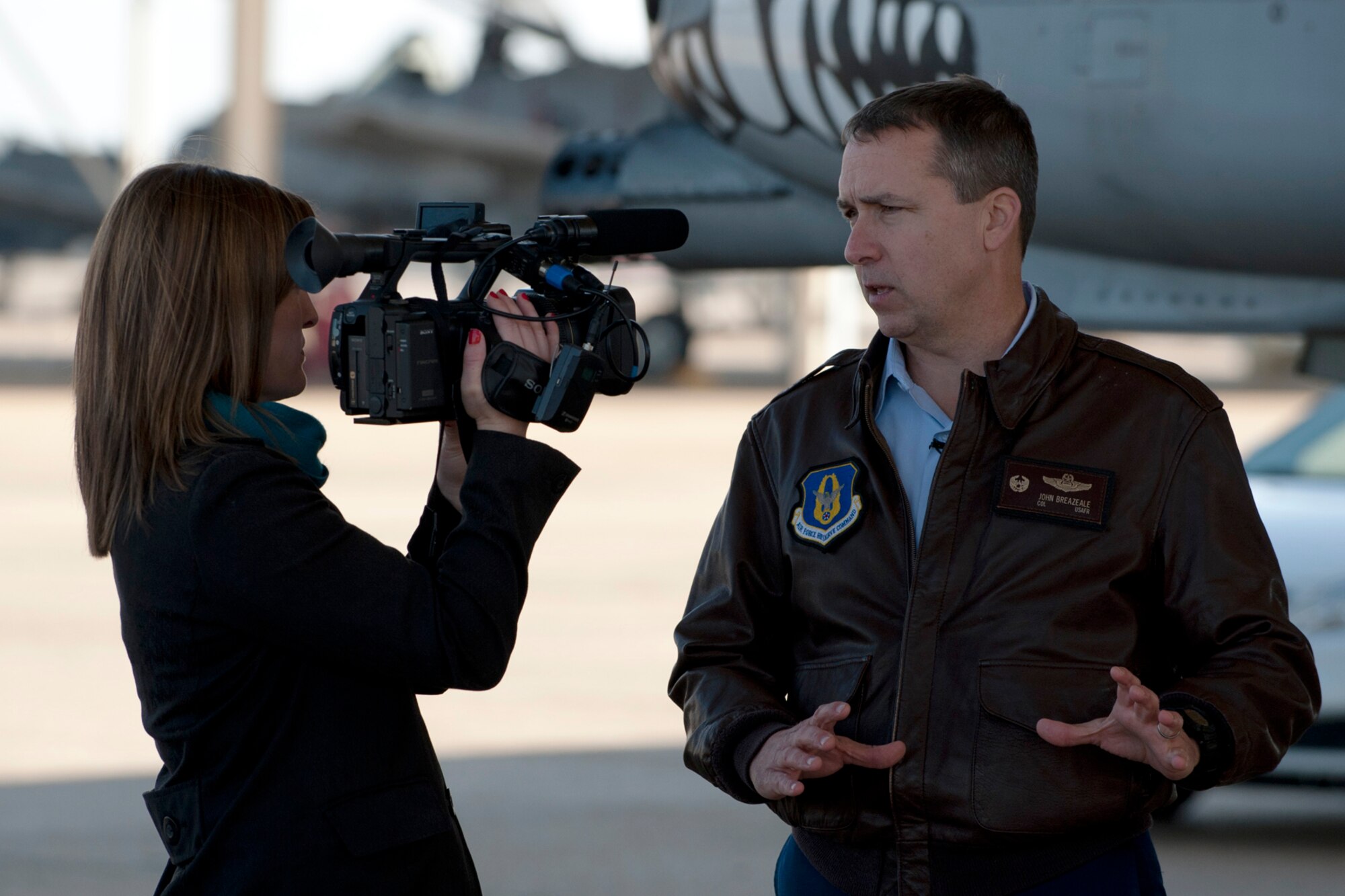U.S. Air Force Lt. Col. John Breazeale, 917th Fighter Group commander, is interviewed by Adria Goins, KSLA News12 reporter/anchor, beside an A-10 Thunderbolt II aircraft, Barksdale Air Force Base, La., Feb. 6, 2012. The interview focused on the recent Department of Defense decision to cut 21 A-10s from Barksdale (U.S. Air Force photo by Master Sgt. Greg Steele/ Released)