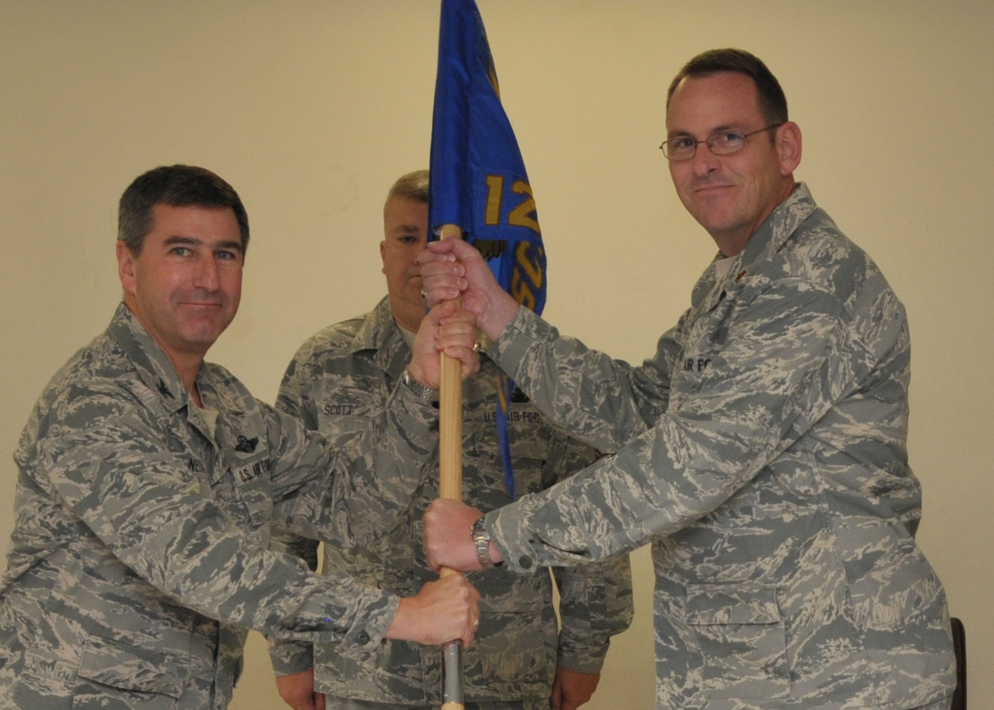 Maj. Evan Cozadd (right) accepts the 126th Supply Chain Management Squadron guidon from Col. Peter Nezamis, commander, 126th Air Refueling Wing, at Scott AFB, Ill., on Nov. 5, 2011. Maj. Cozadd brings more than 20 years of experience in the logistics arena and the Illinois Air National Guard with him to this position. The 126 SCMS is the 126 ARW’s Classic Associate Total Force Integration squadron embedded within the Active Duty Air Force Global Logistic Supply Center. (National Guard photo by Master Sgt. Franklin Hayes)