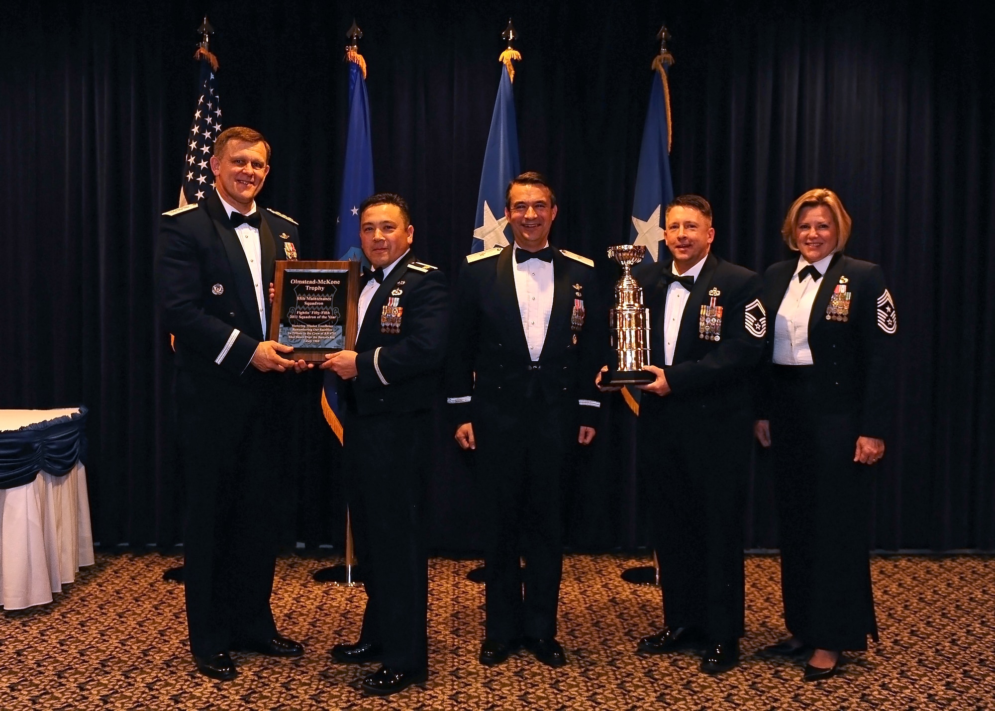 Lt. Gen. Frank Gorenc, 3rd Air Force commander, presents Maj. Frank Shifflett, 55th Maintenance Squadron commander, a plaque commemorating the 55th MXS as squadron of the year while Senior Master Sgt. Becker, 55th MXS superintendent, holds the Olmstead-McKone Squadron of the Year trophy. Also pictured are Brig. Gen. Donald Bacon, 55th Wing commander, and Chief Master Sgt. Suzan Sangster, 55th Wing command chief. This was the first time the Olmstead-McKone trophy has been awarded.  (U.S. Air Force Photo by Josh Plueger/Released)