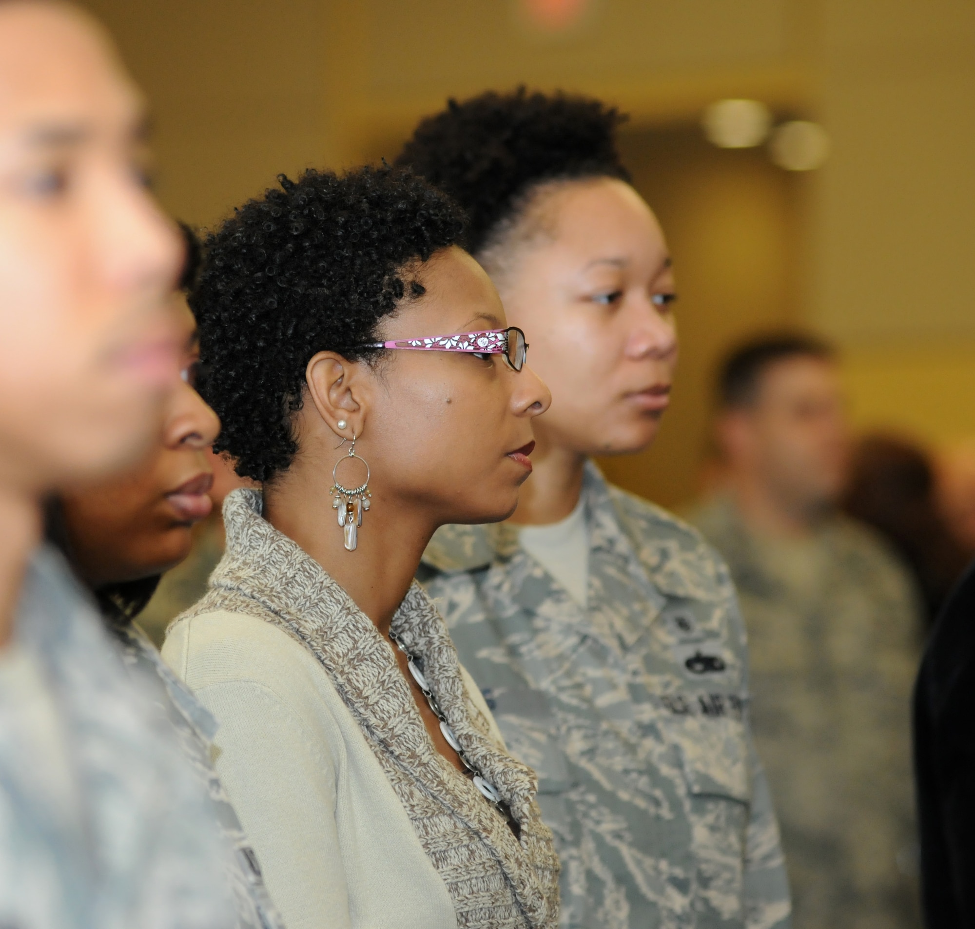 Antoinette Vinson and Staff Sgt. Andrea Jones, 81st Medical Support Squadron, stand in the audience as the colors are posted during the Black History Month luncheon, Feb. 2, 2012, at the Bay Breeze Event Center, Keesler Air Force Base, Miss.  The luncheon was hosted by the African American Heritage Committee and the guest speaker for the event was Sally-Ann Roberts.  (U.S. Air Force photo by Kemberly Groue)