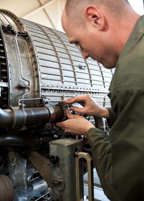 Staff Sgt. Luke Keigley, 28th Maintenance Squadron aerospace propulsion journeyman, secures and tightens an anti-ice valve on a B-1B engine at Ellsworth Air Force Base, S.D., Jan. 18, 2012. This protects the engine from damage by flowing bleed air to the inlet guide veins which melts potential ice build up, preventing damage to the fan blades. (U.S. Air Force photo by Airman Alystria Maurer/Released)