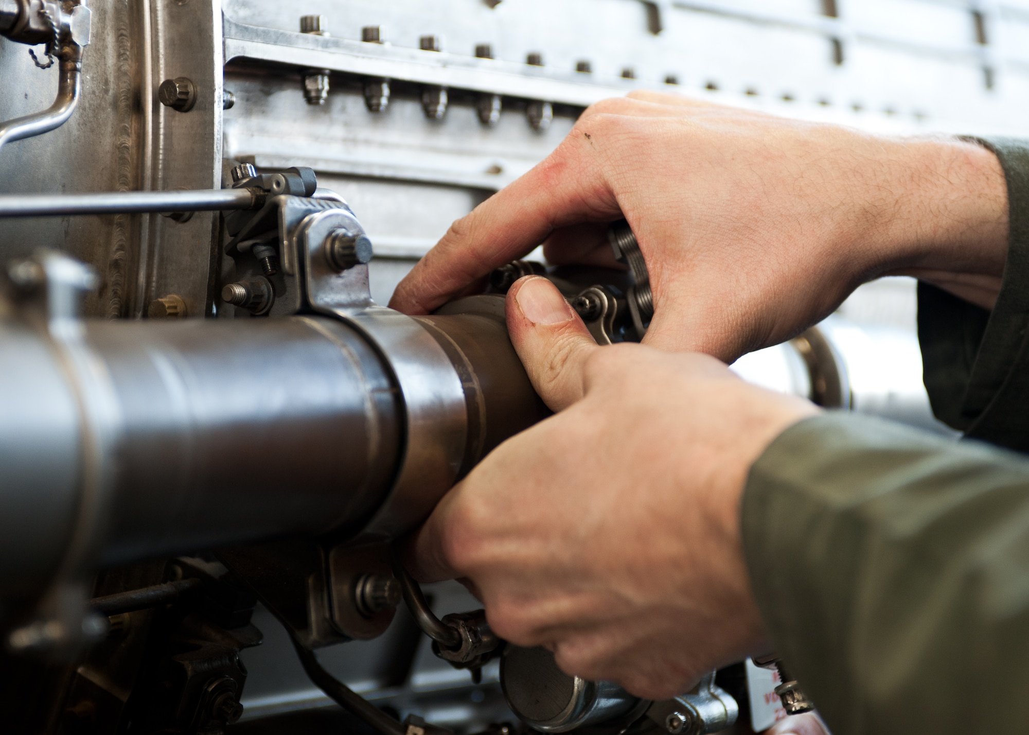 Staff Sgt. Luke Keigley, 28th Maintenance Squadron aerospace propulsion journeyman, installs an anti-ice valve onto a B-1B engine at Ellsworth Air Force Base, S.D., Jan. 18, 2012. The anti-ice valve prevents ice build up that can potentially damage the fan blades. (U.S. Air Force photo by Airman Alystria Maurer/Released)