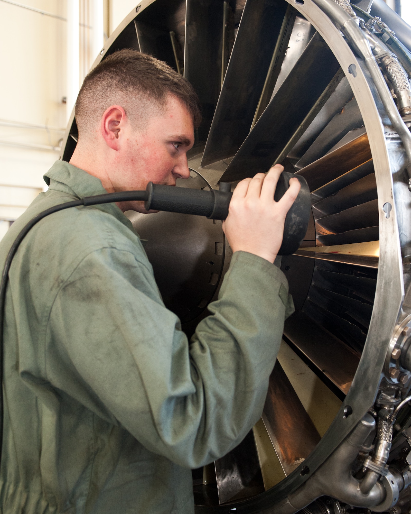 Senior Airman Steven Durr, 28th Maintenance Squadron aerospace propulsion journeyman, inspects fan blades on a B-1B engine at Ellsworth Air Force Base, S.D., Jan. 18, 2012. Airmen in the propulsion back shop use this engine during training to identify different foreign object debris damage that can occur. (U.S. Air Force photo by Airman Alystria Maurer/Released)