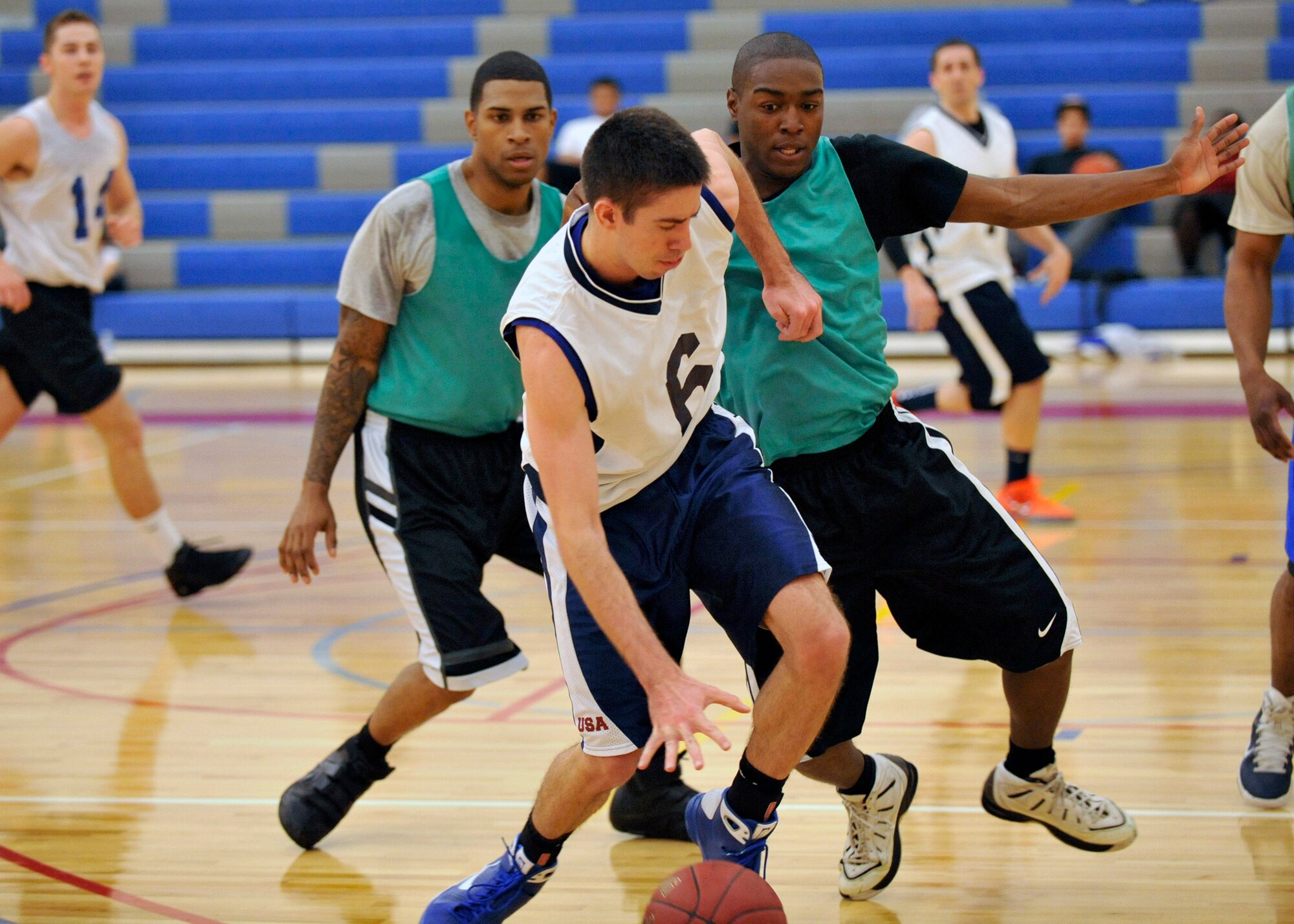 Hunter Myers, 436th Communications Squadron player-coach, attempts to dribble out of trouble while two 436th Security Forces Squadron defenders attempt to trap him along the sideline during an intramural basketball game Feb. 2, Dover Air Force Base, Del. Myers scored a game-high 17 points to lead the 436th CS to a 46-31 upset victory against the 436th SFS. (U.S. Air Force photo by Tech. Sgt. Chuck Walker)