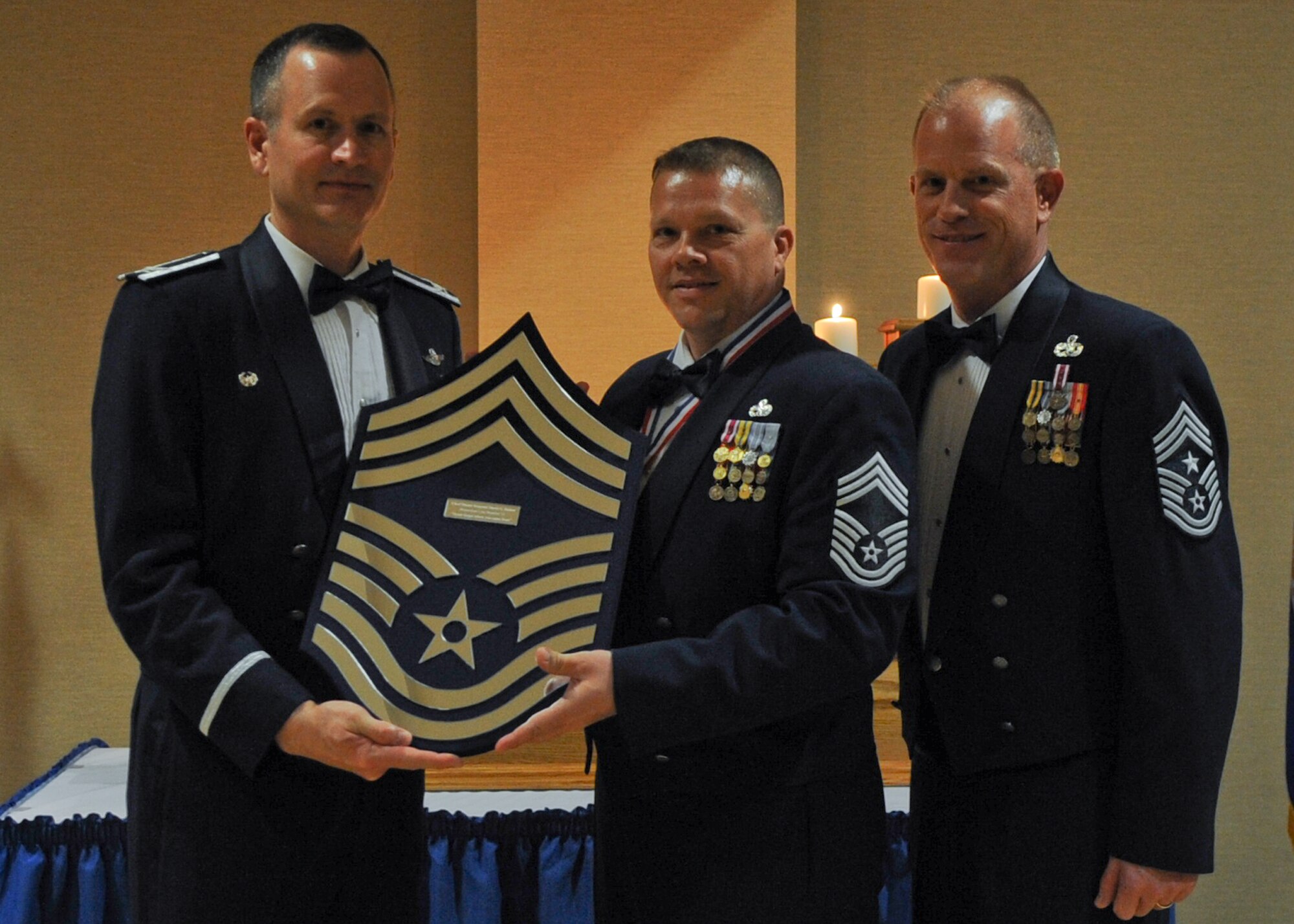 U.S. Air Force Chief Master Sgt. David Barker, 23d Component Maintenance Squadron superintendent, poses for a photo with Col. Billy Thompson, 23d Wing commander, and Chief Master Sgt. Frank Batten, 23d Wing command chief, during a Chief Recognition Ceremony at Moody Air Force Base, Ga., Feb. 4, 2012. Barker, along with Chief Master Sgts. Thomas Moore, 23rd Maintenance Group Quality Assurance superintendent, Tyrone Robinson, 93d Air Ground Operations Wing intelligence superintendent, and McKinney Crawford, 763rd Maintenance Squadron at Nellis Air Force Base, Nev., were promoted to the highest enlisted rank of Chief Master Sgt. (U.S. Air Force photo by Airman 1st Class Olivia Dominique/Released)