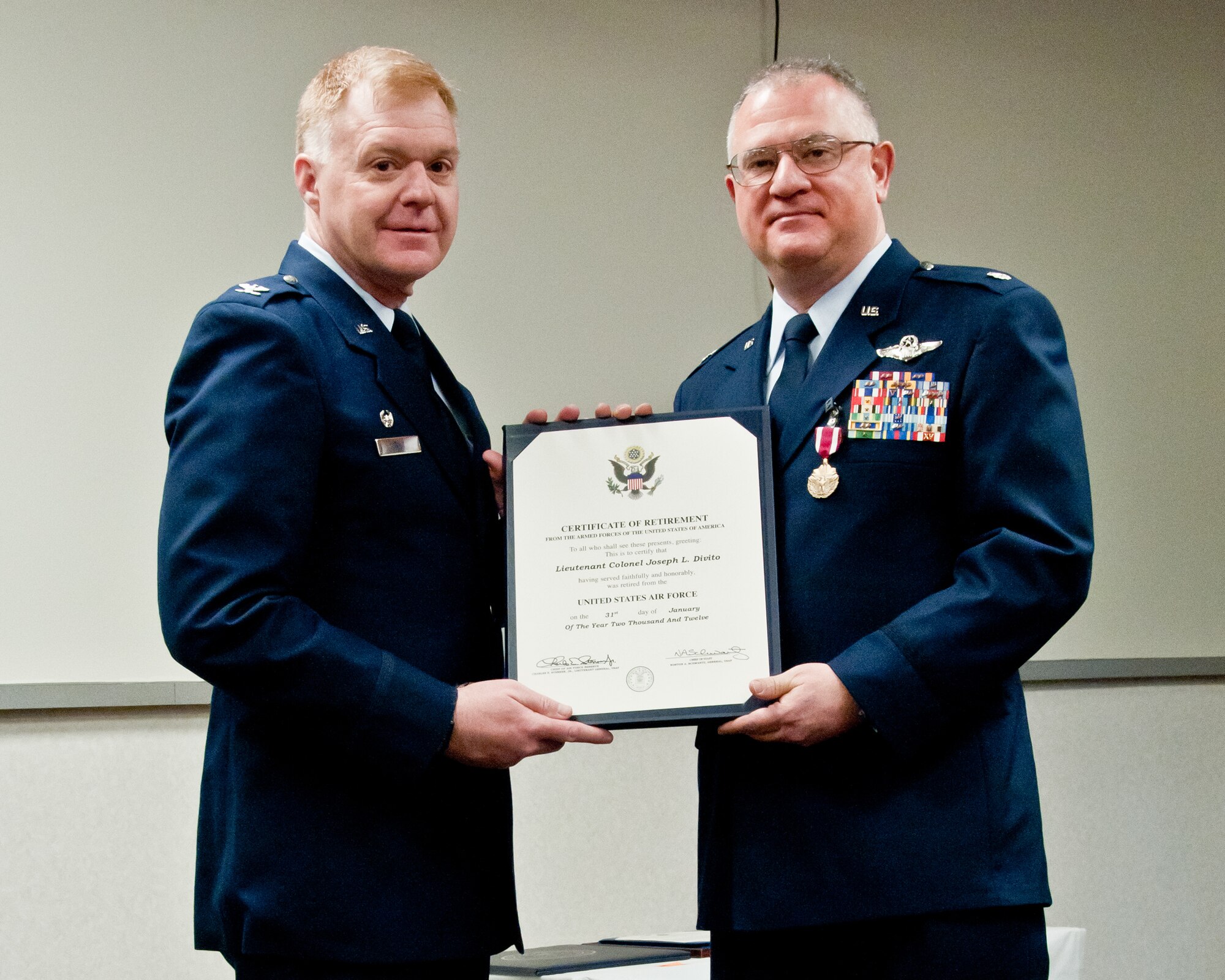 Col. Ron Wilt, commander of the 934th Operations Group, presents Lt. Col. Joseph L. Divito with a certificate commemorating his 29 years of service at his retirement ceremony. (Air Force Photo/TSgt. Jim Loehr)