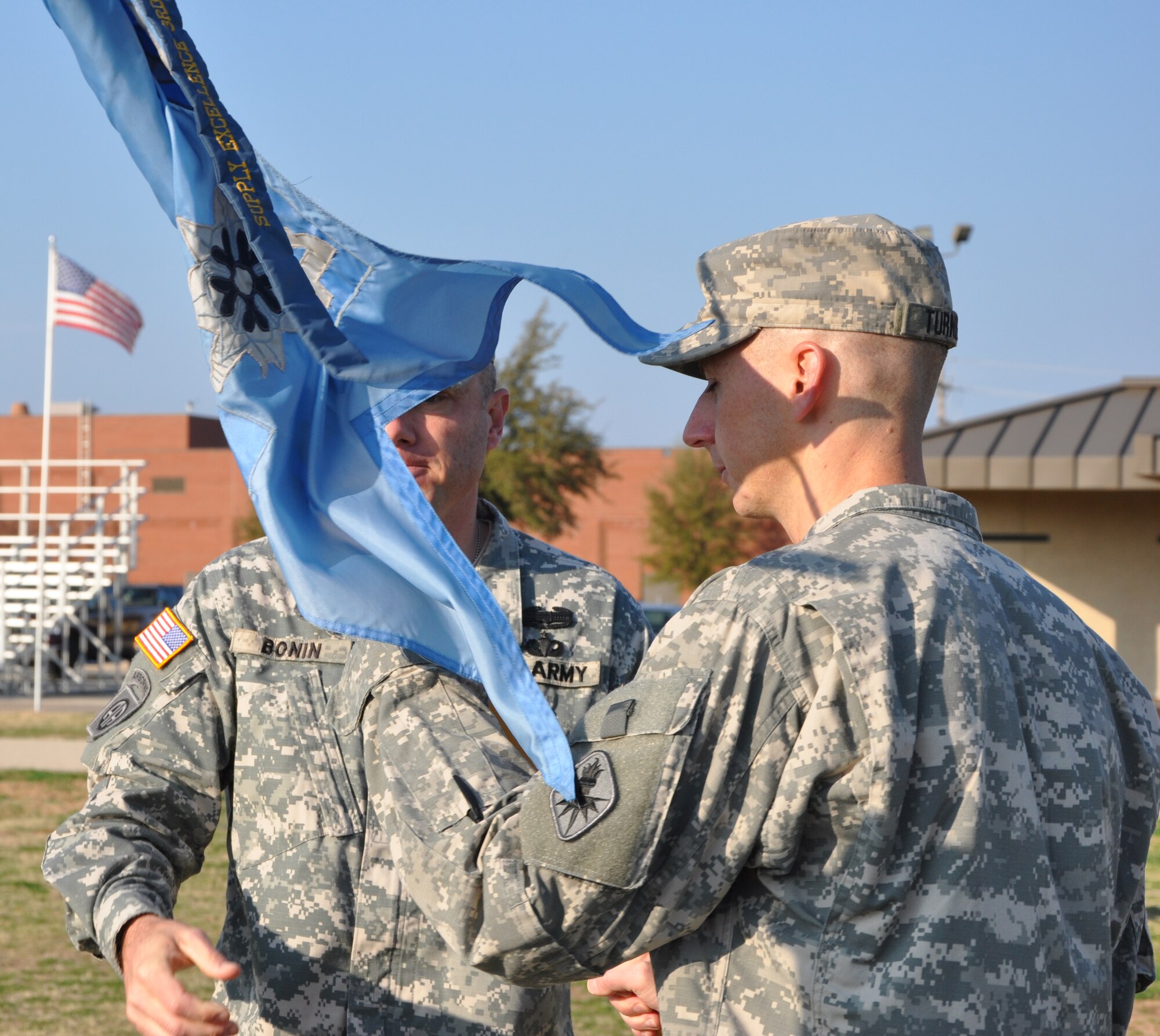 GOODFELLOW AIR FORCE BASE, Texas—Army Capt. Kevin Turnblom receives the 344th Military Intelligence Battalion Alpha Company’s guidon from Army Lt. Col. John Bonin during a change of command ceremony on the parade field here Feb. 3.  Capt. Turnblom was previously stationed at Ft. Huachuca,  Ariz. (U.S. Air Force photo/Airman 1st Class Jessica Keith) 