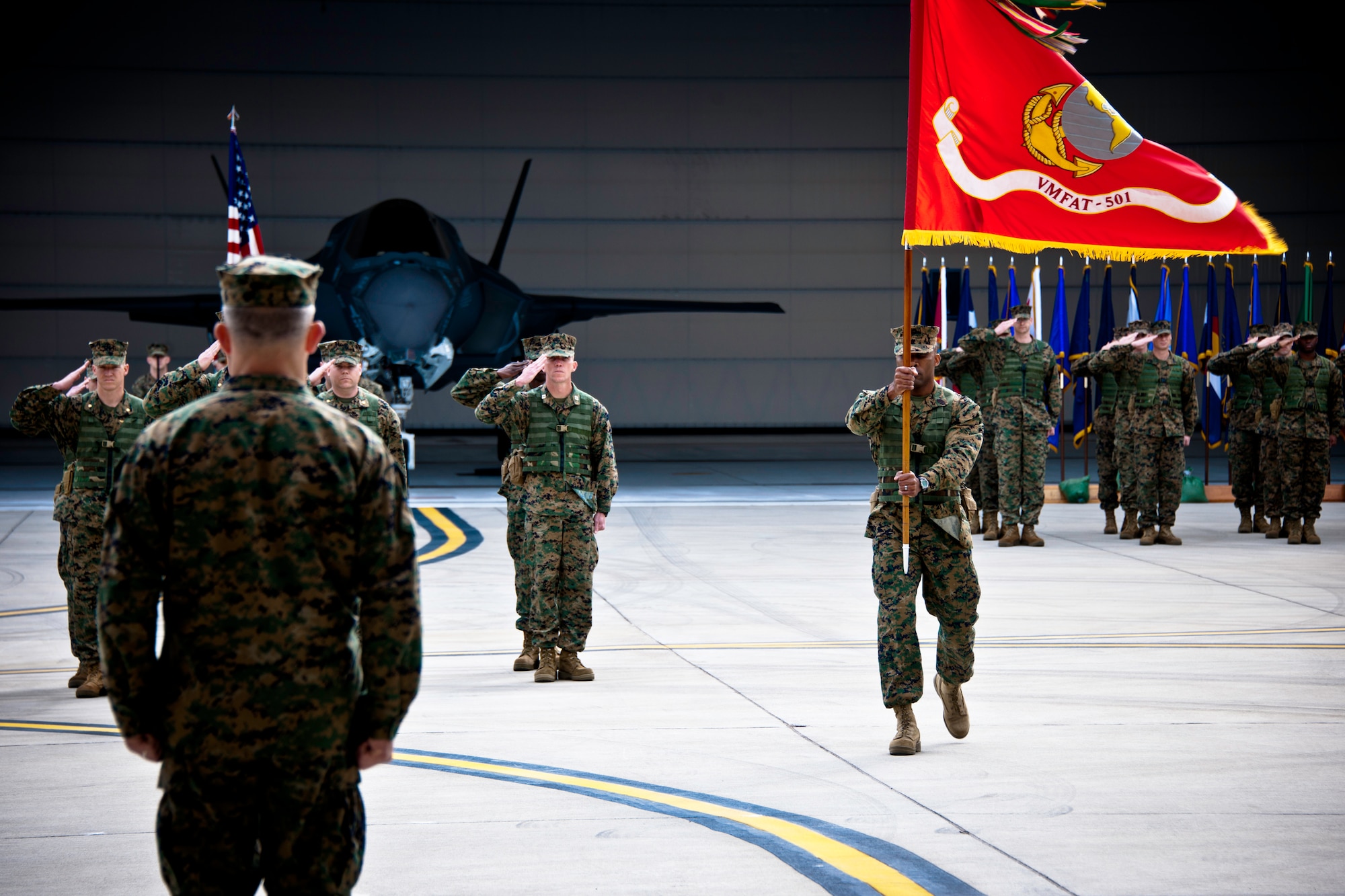 Sgt. Maj. David Stocks brings the Marine Fighter Attack Squadron 501 guidon to Lt. Col. James Wellons, the outgoing commander, during the squadron’s change of command ceremony Feb. 3 at Eglin Air Force Base, Fla.  The squadron stood up in April 2010 and currently has approximately 89 Marines here.  (U.S. Air Force photo/Samuel King Jr.)