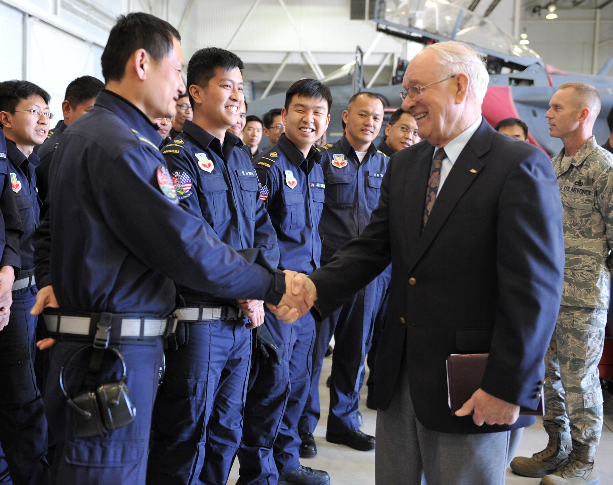 Chief Master Sgt. (retired) Sam E. Parish, who served as the 8th Chief Master Sergeant of the Air Force from 1983 - 1986, introduces himself to Republic of Singapore Air Force 428th Fighter Squadron airmen Feb. 3, 2012, at Mountain Home Air Force Base, Idaho. Chief Parish expressed how impressed he was with today’s Air Force preparing Airmen for the future and the great partnerships the service has established with other nations. (U.S. Air Force photo by Airman 1st Class Heather Hayward)