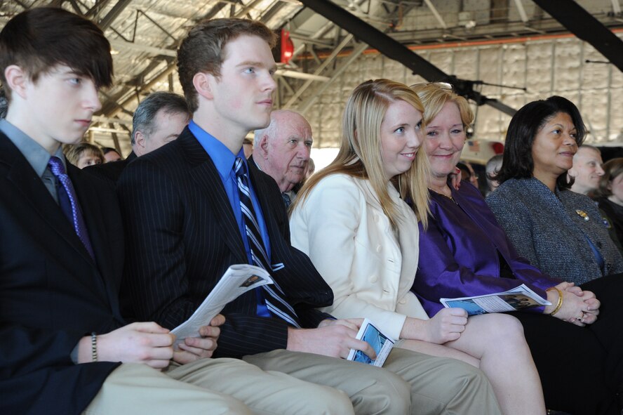 The family of Col. Jeffrey W. Macdonald, Air Force District of Washington individual mobilization augmentee to the commander, embraces the heartfelt ceremony, Feb. 3 on Joint Base Andrews, Md., as Macdonald retires after more than 30 years of dedicated service. (U.S. Air Force photo by Airman 1st Class Tabitha N. Haynes)