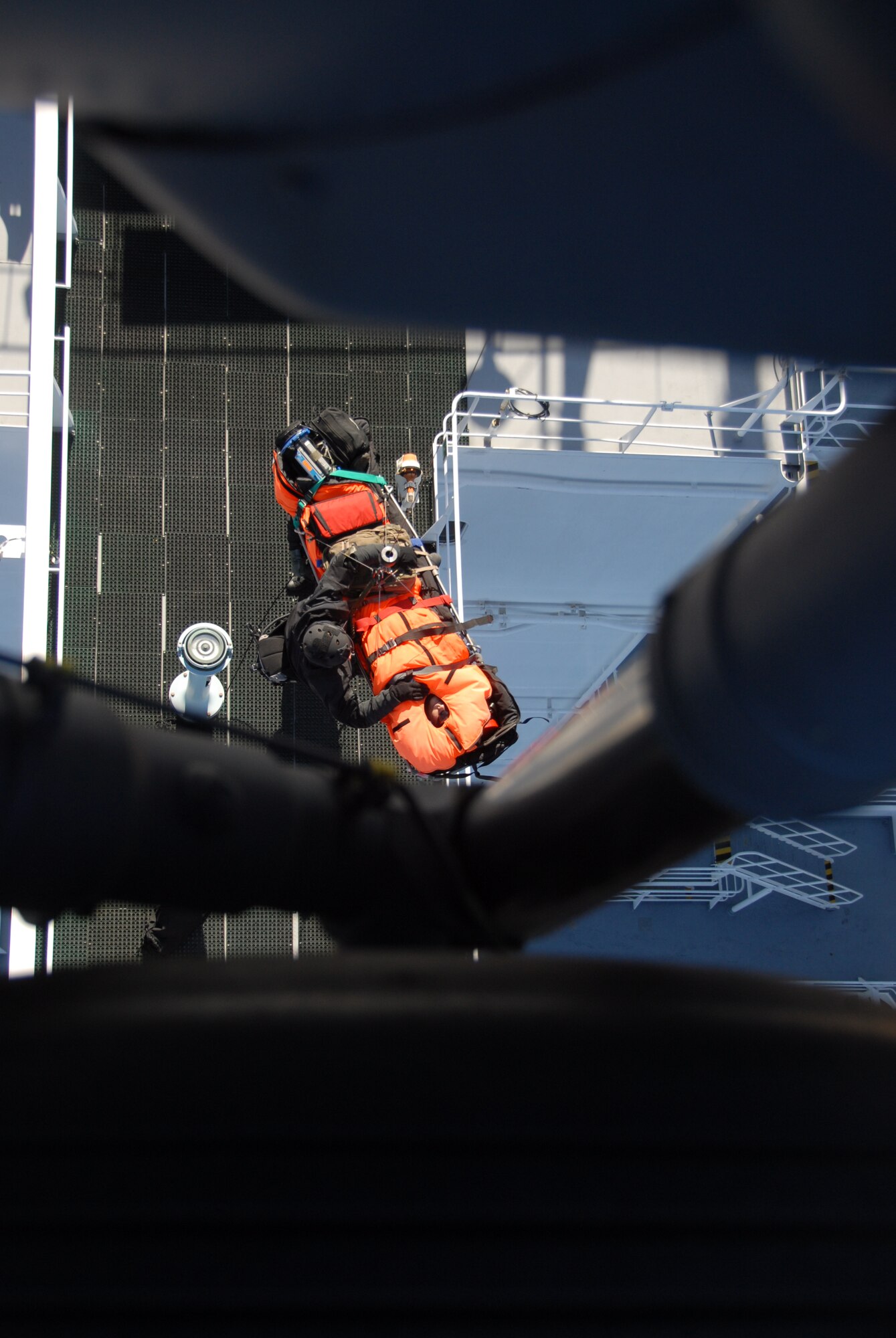Staff Sgt. Adam Vanhaaster attaches a hoist to a patient’s litter to be lifted into a HH-60G Pave Hawk rescue helicopter Feb. 4, 2012, 200 miles off the coast of California. Responding to a call from the Eleventh District Coast Guard at Alameda, Calif., pararescuemen, two Pave Hawks and one MC-130P Combat Shadow aircraft, all from the 129th Rescue Wing, rescued a man suffering stroke-like symptoms aboard the MSC Beijing. Vanhaaster is a pararescueman assigned to the 131st Rescue Squadron at Moffett Federal Airfield, Calif.  (Air National Guard photo/Senior Airman Jessica Green)