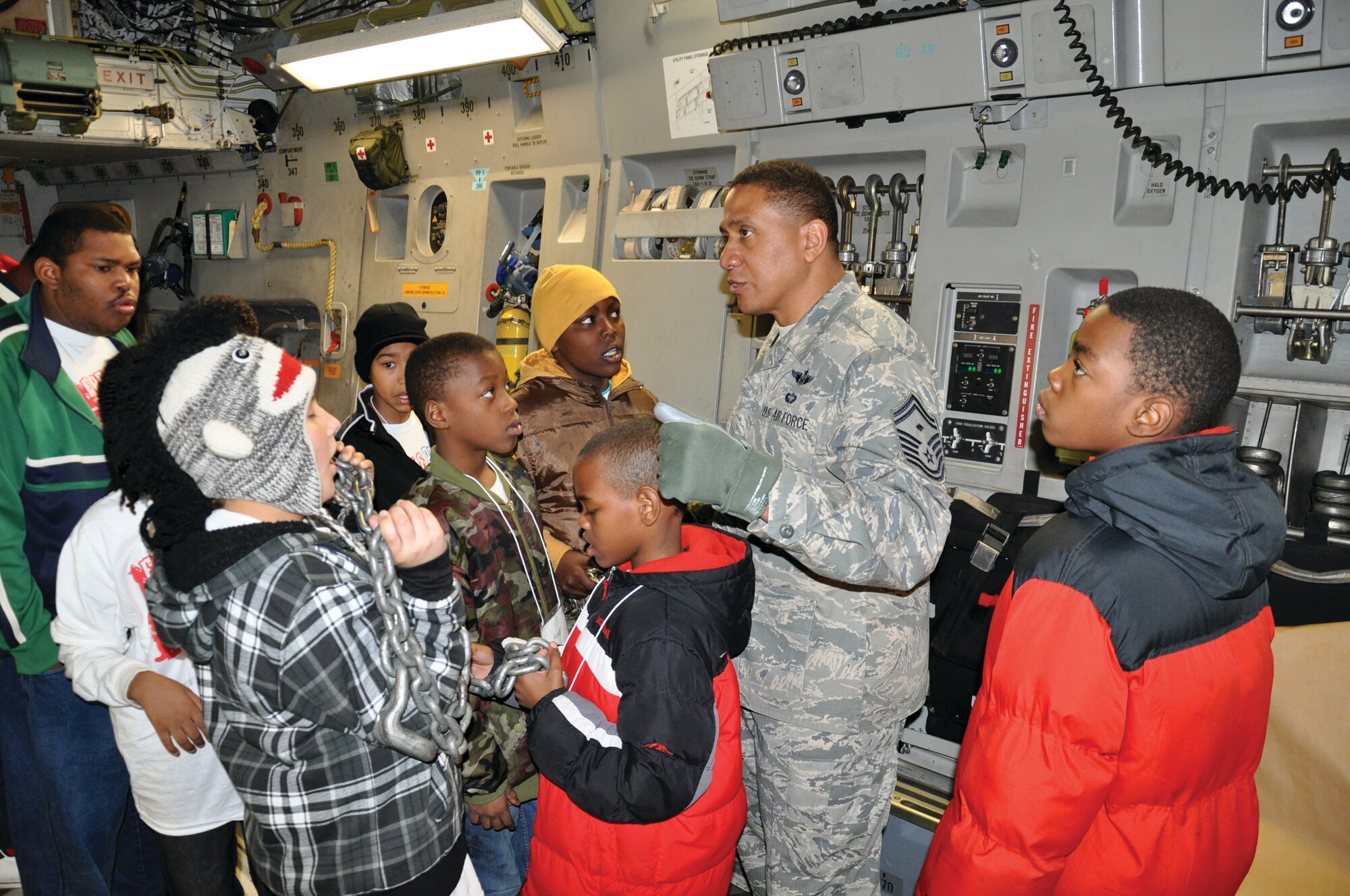 WRIGHT-PATTERSON AIR FORCE BASE, Ohio - Senior Master Sgt. James Felton, 445th Aircraft Maintenance Squadron first sergeant, shows a group of children the C-17 Globemaster III as part of their visit to the 445th Airlift Wing Jan. 7. The children are part of a program sponsored by the Charleston, W. Va., Black Ministerial Alliance’s Church in the City in concert with Charleston’s Police Department to bring inner city youths together to participate in a variety of activities. (U.S. Air Force photo/Master Sgt. Charles Miller)