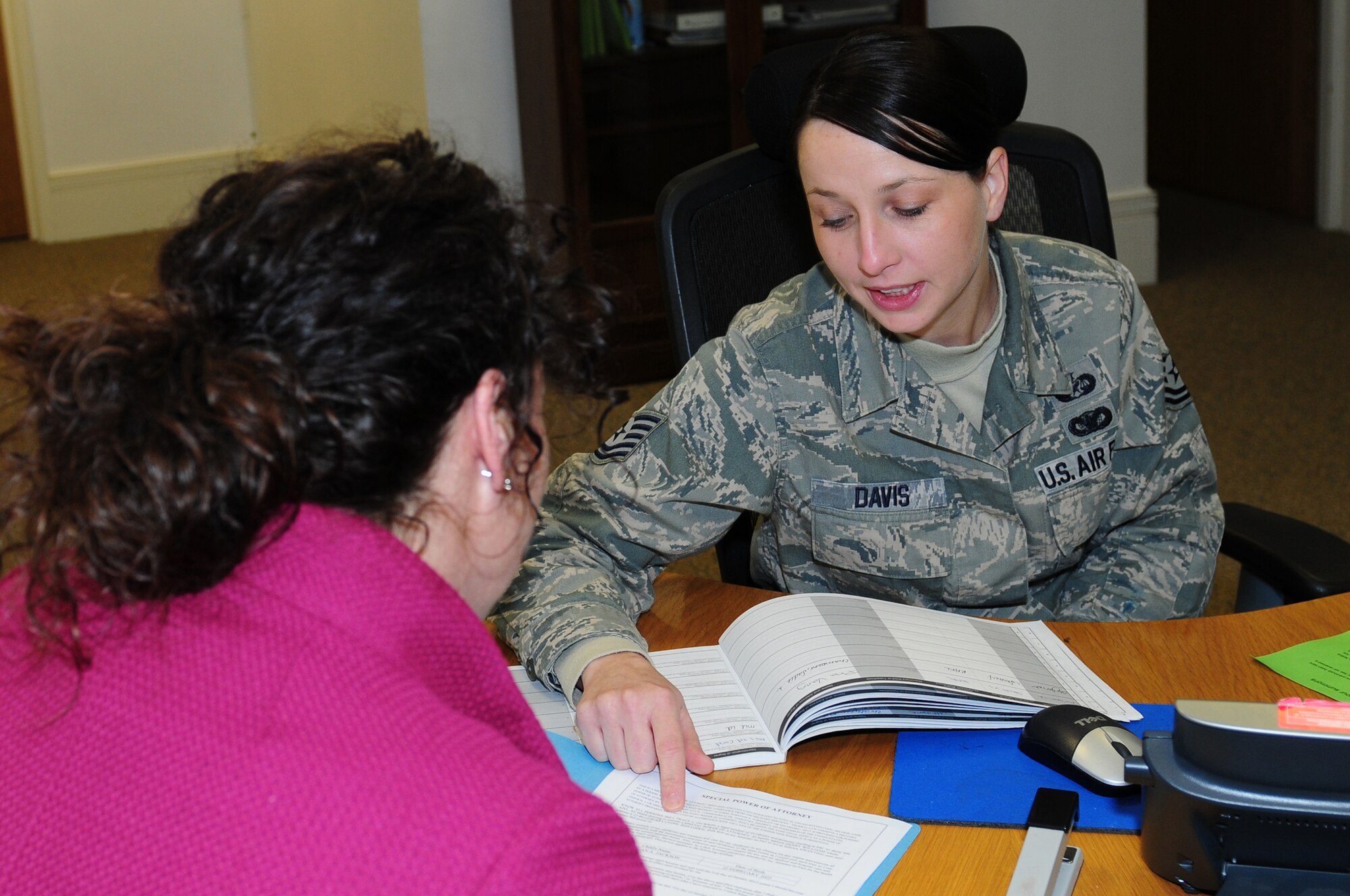 ROYAL AIR FORCE LAKENHEATH, England -- Tech. Sgt. Kristen Davis, 48th Fighter Wing Judge Advocate NCO in charge of administrative law, helps a customer, Jan. 30, 2012. Davis was nominated for a Liberty Spotlight because she displays the core value of 'Excellence in All We Do'. (U.S. Air Force photo by Airman 1st Class Cory D. Payne)
