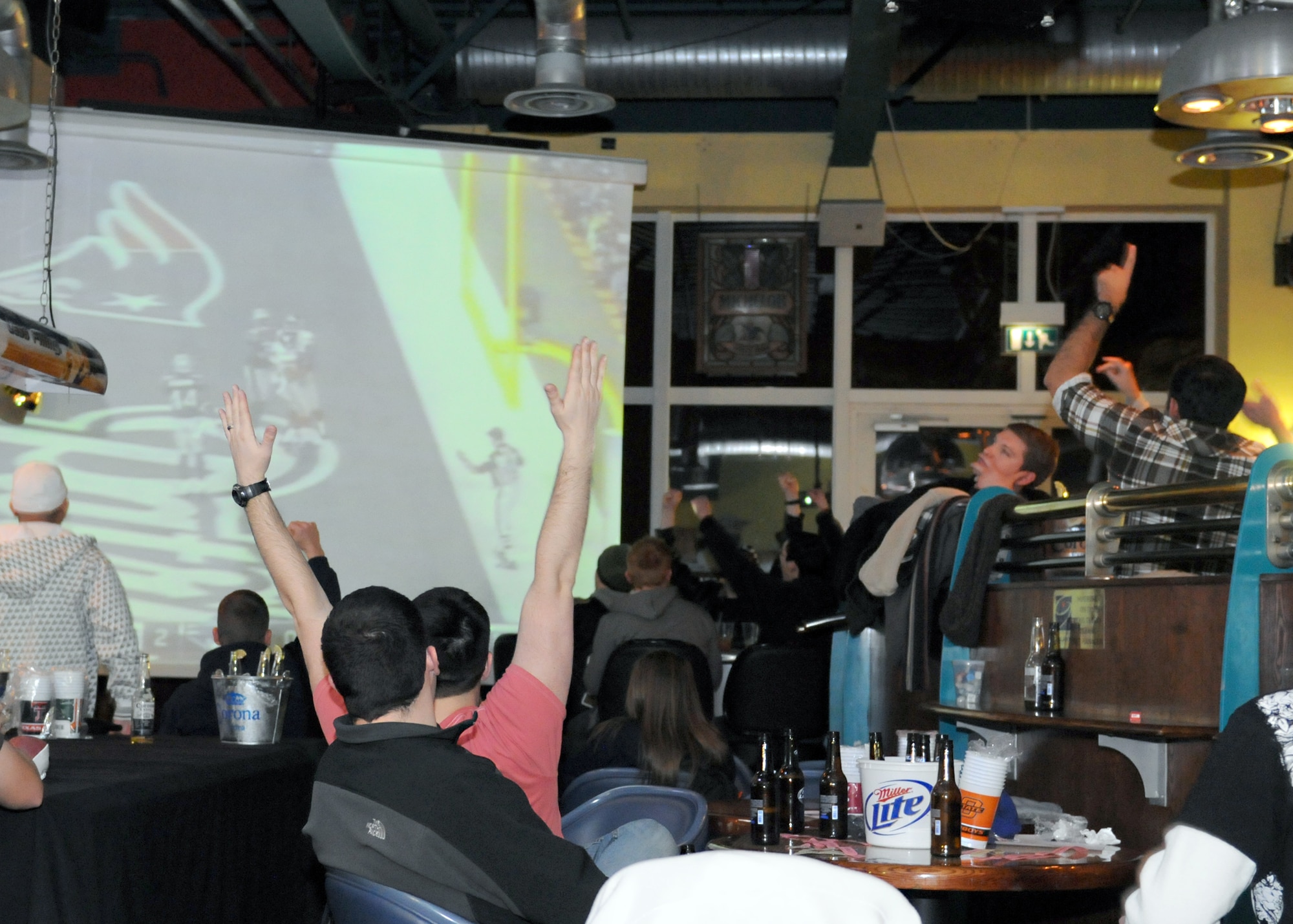 RAF MILDENHALL, England – New York Giants fans cheer, at the Galaxy Club Superbowl party Feb. 5, 2012, as their team scores the first touchdown of the 2012 Superbowl.  Military members serving overseas often miss out on common American pastimes; however, the members of the 100th Force Support Squadron work hard throughout the year to bring American culture to Airmen abroad through events like this. (U.S. Air Force photo/Staff Sgt. Tabitha M. Lee)