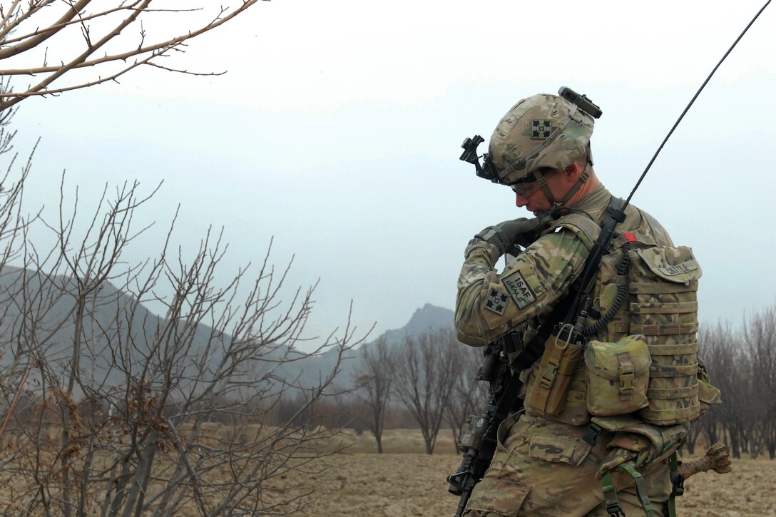 U.S. Army 1st Lt. Austin Cattle calls in a situation report to his commander during a joint clearance operation with Afghan police in western Kandahar, Afghanistan, Feb. 1, 2012. Cattle is assigned to the 4th Infantry Division's Company B, 1st Battalion, 67th Armor Regiment, 2nd Brigade Combat Team.
