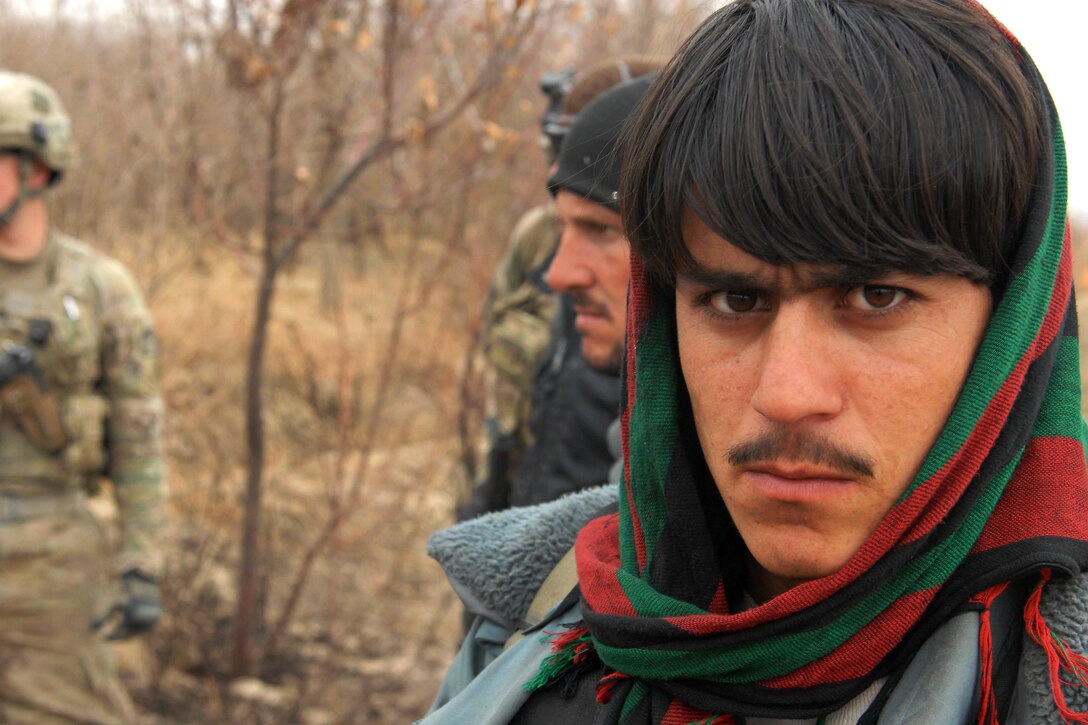 An Afghan policeman takes a moment to reflect during a joint clearance ...