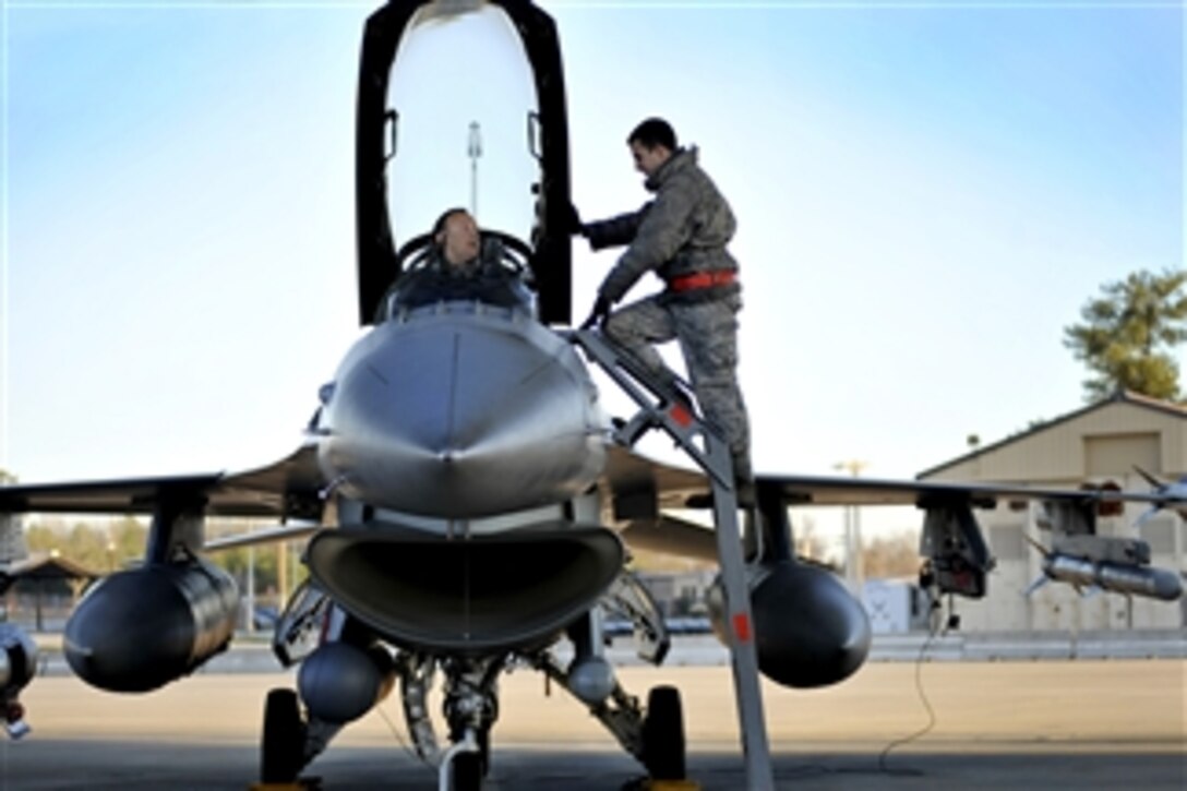 Capt. Jason Blodzinski, a 77th Fighter Squadron pilot, talks with his crew chief, Senior Airman Frank Brown, also with the 77th Fighter Squadron, before launching an F-16 Fighting Falcon during an operational readiness exercise at Shaw Air Force Base, S.C., on Jan. 31, 2012.  The exercise evaluated the 20th Fighter Wingís ability to meet wartime and contingency tasks.  