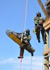 STUMP NECK ANNEX, Md. (April 6, 2011) Technical rescue platoon members with the Marine Corps Chemical Biological Incident Response Force, Sgt. Jafri Leahy (center) and Cpl. Michael Harvey (r.) demonstrate a high-to-high rope rescue at the command's Downey Responder Training Facility. While suspended three stories in the air, they secured an "unconscious" LCpl. Keith Saffran onto a rescue stretcher prior to lowering the victim to the ground. The demonstration was part of a day-long visit to CBIRF earlier this month by Lt.Gen. John Paxton Jr., Commanding General II Marine Expeditionary Force. 