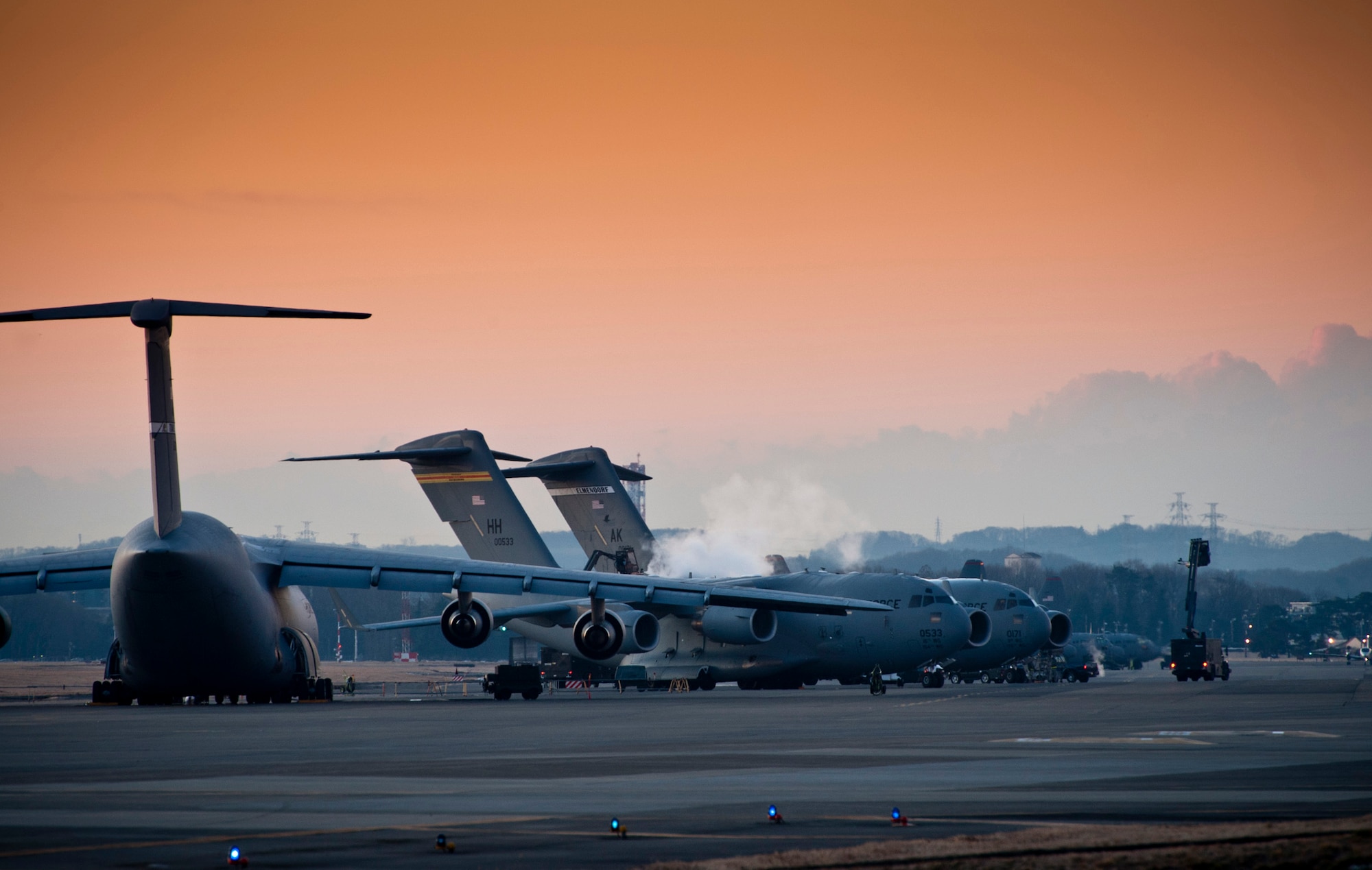 YOKOTA AIR BASE, Japan -- Dawn breaks over the flightline at Yokota Air Base, Japan, Jan. 31, 2012. Yokota serves as the hub for tactical airlift in the western Pacific. (U.S. Air Force photo/Staff Sgt. Samuel Morse)