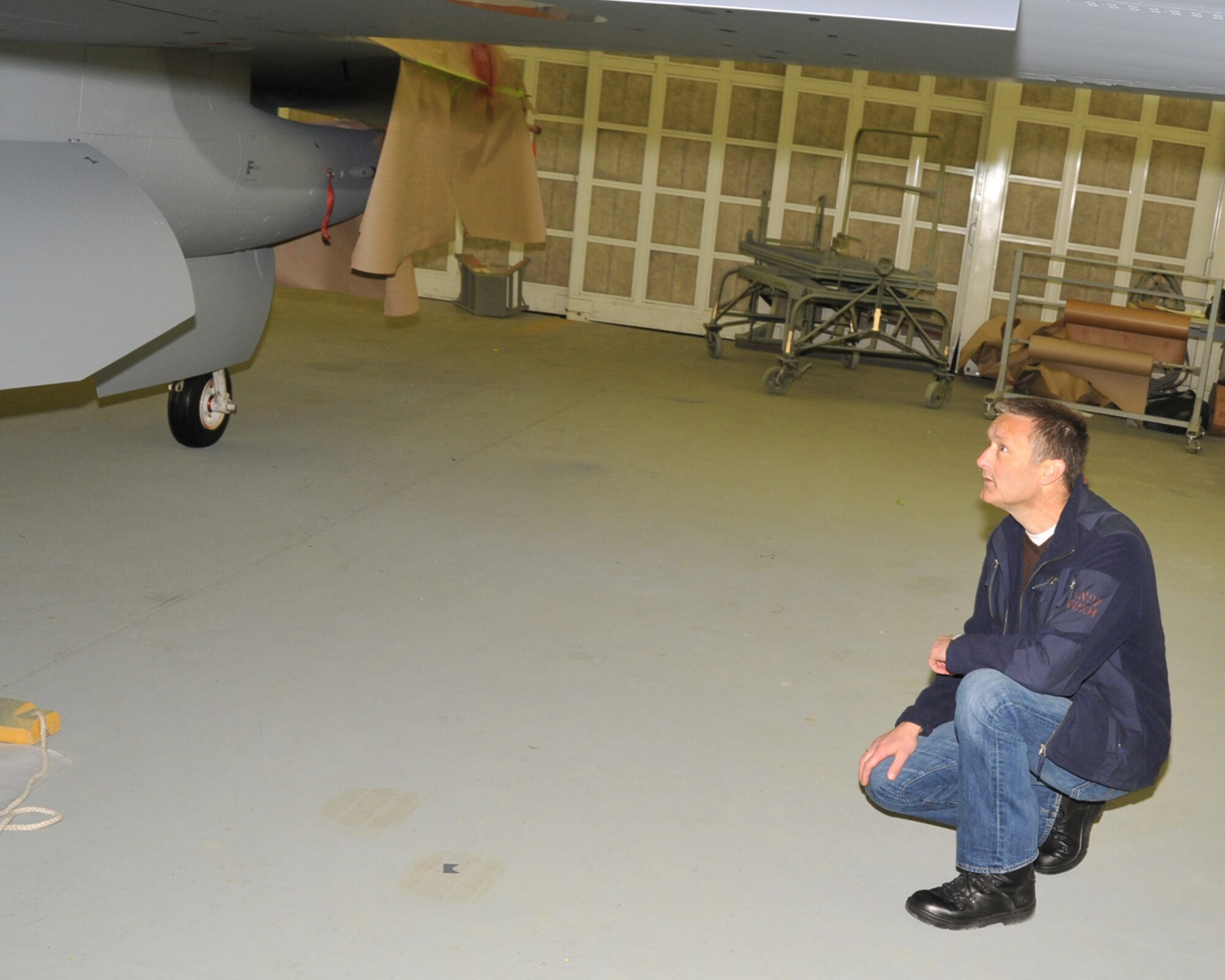 Major Jos Oudshoorn of the Royal Netherlands Air Force, inspects his freshly painted F-16. The Iowa Air National Guard Paint Facility, Sioux City, Iowa, was contracted to paint six Dutch F-16s in 2012. This is the first time the paint facility has worked with an international aircraft. 

USAF Photo Staff Sgt. Rich Murphy, 185th Air Refueling Wing, Iowa Air National Guard (released) 