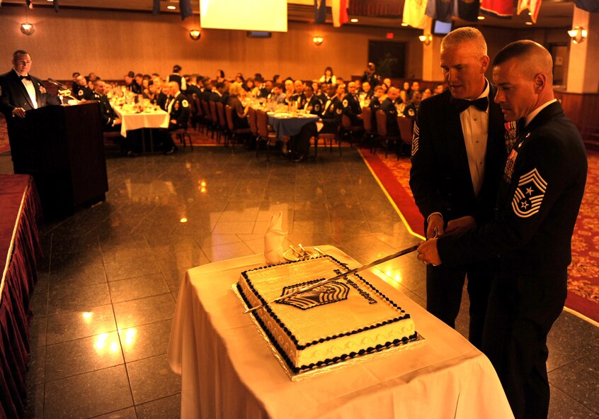 U.S. Air Force Chief Master Sgt. Mark D. Marson, 18th Wing command chief, and Chief Master Sgt. Brooke P. McLean, Pacific Air Forces command chief, cut the cake together during the 2012 Kadena Chiefs Recognition Ceremony on Kadena Air Base, Japan, Jan. 28, 2012. The 2012 Kadena Chiefs Recognition Ceremony is organized by Kadena's chiefs who were promoted the previous year. (U.S. Air Force photo by Airman 1st Class Justin Veazie) 